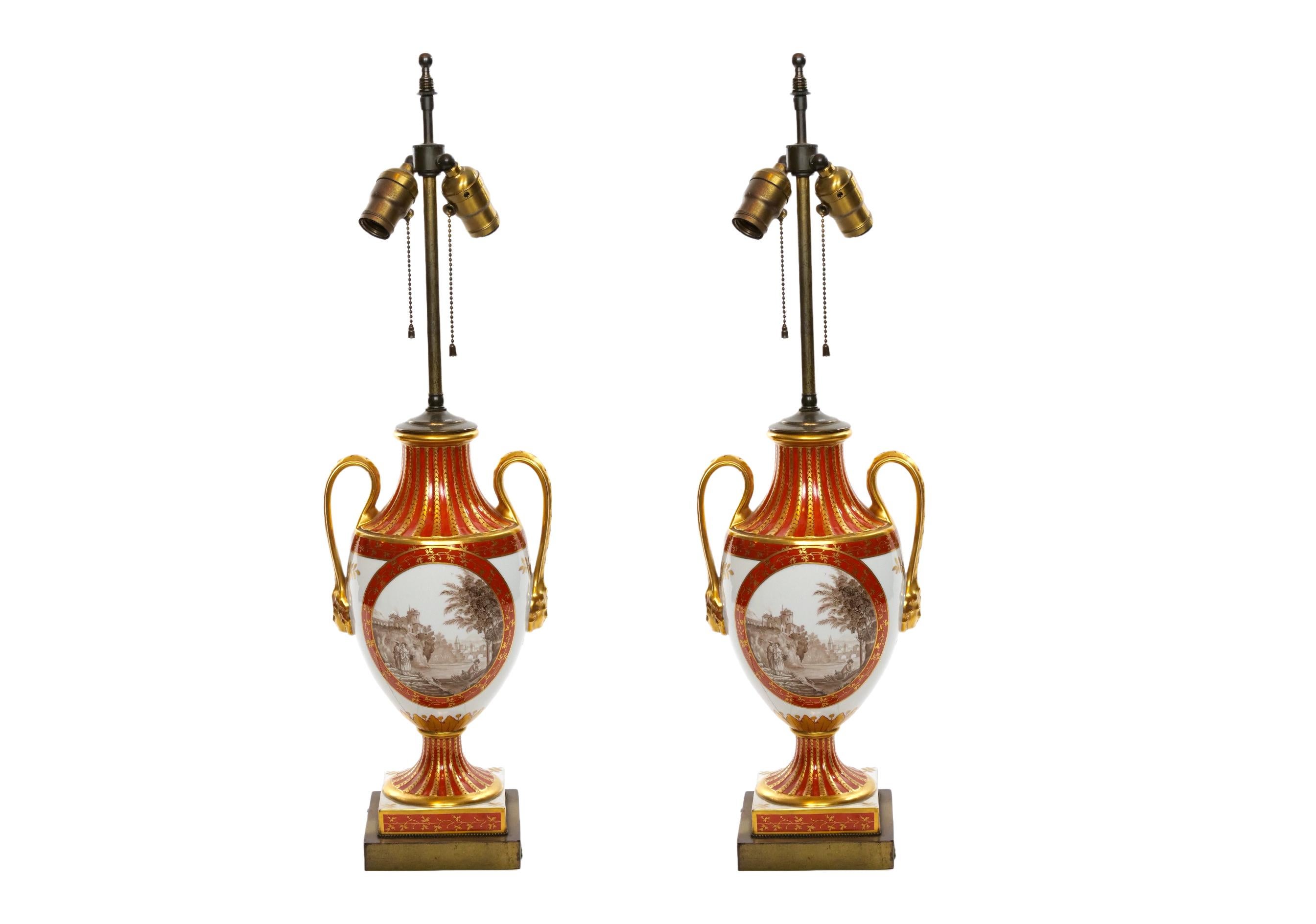 Louis XVI style French porcelain and gilt gold dore decorative vase pair table lamp. Each lamp features on one side a painted pastoral promenade scenes signed by a famous artist in the 19th century. The reverse is painted with a different nature