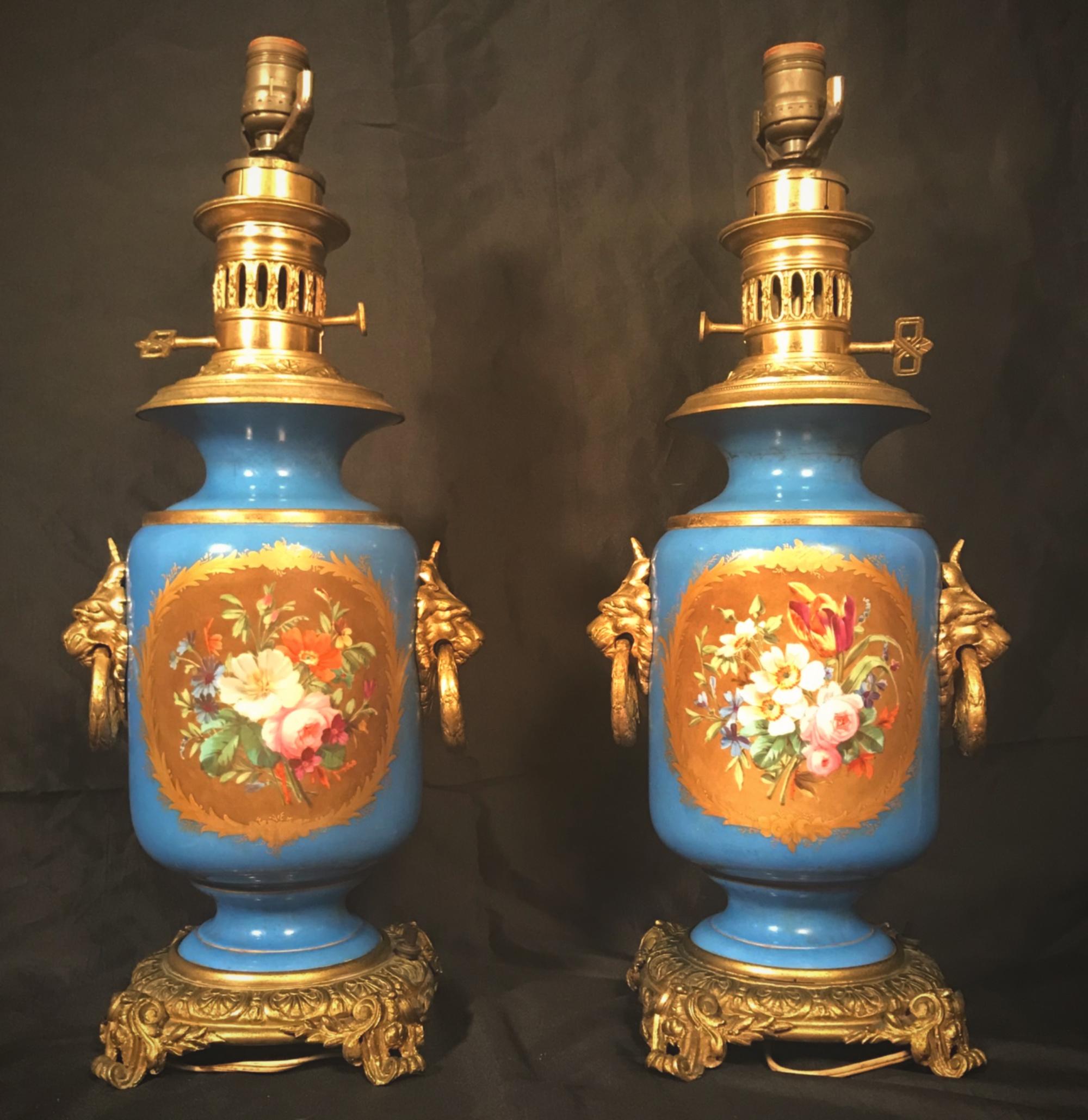 Pair of Louis XVI Style French Sevres blue porcelain hand painted ormolu-mounted oil lamps

This is an exquisite large pair of Sevres blue 19th century enamel hand painted and mounted twin handle table oil lamps. Each front of the Watteau style