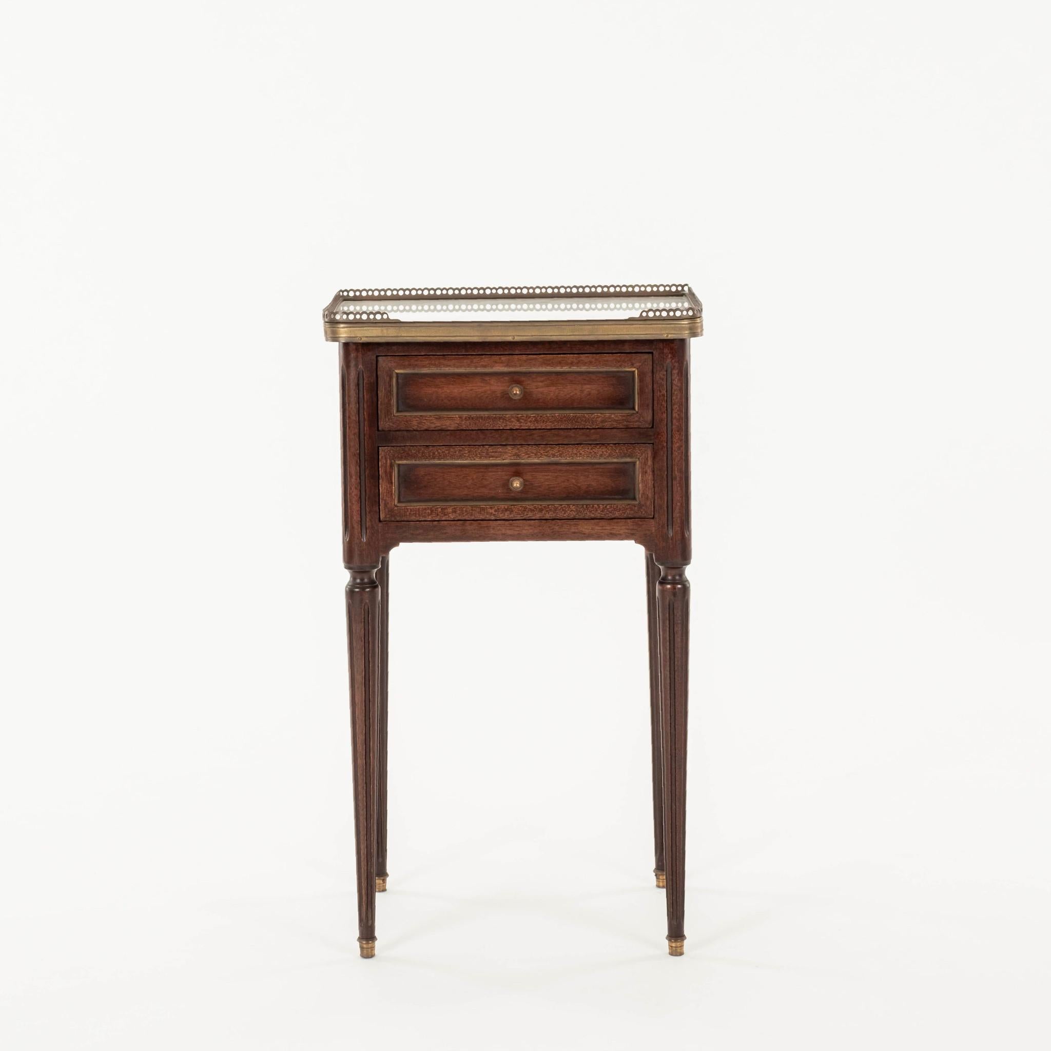 Pair 1940s French Louis XVI style gallery nightstands featuring two drawers with bronze pulls and white marble tops.