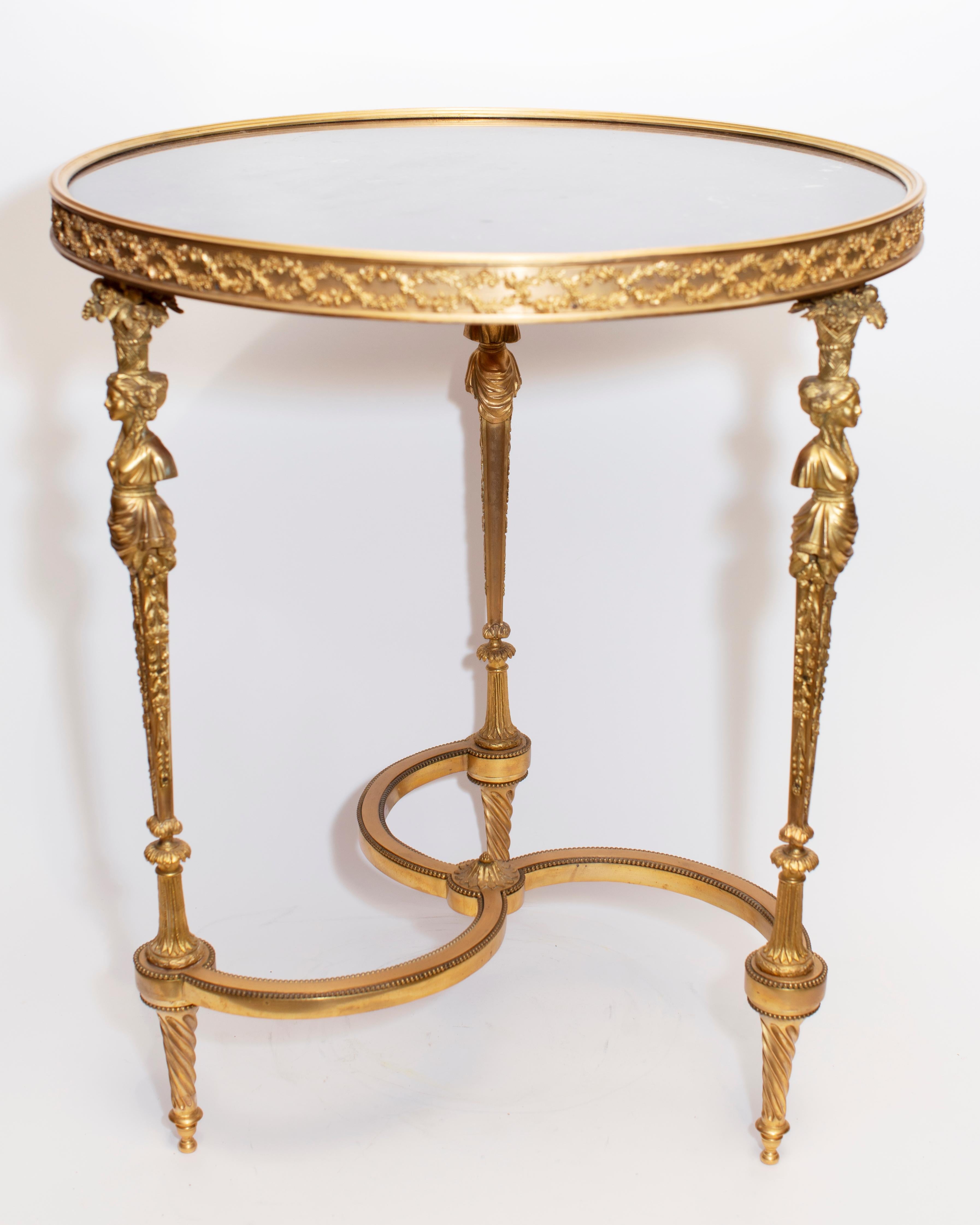 Pair of Louis XVI style, finely sculpted and cast gilt bronze gueridon tables in the manner of Adam Weisweiler (circa 1750-1810).