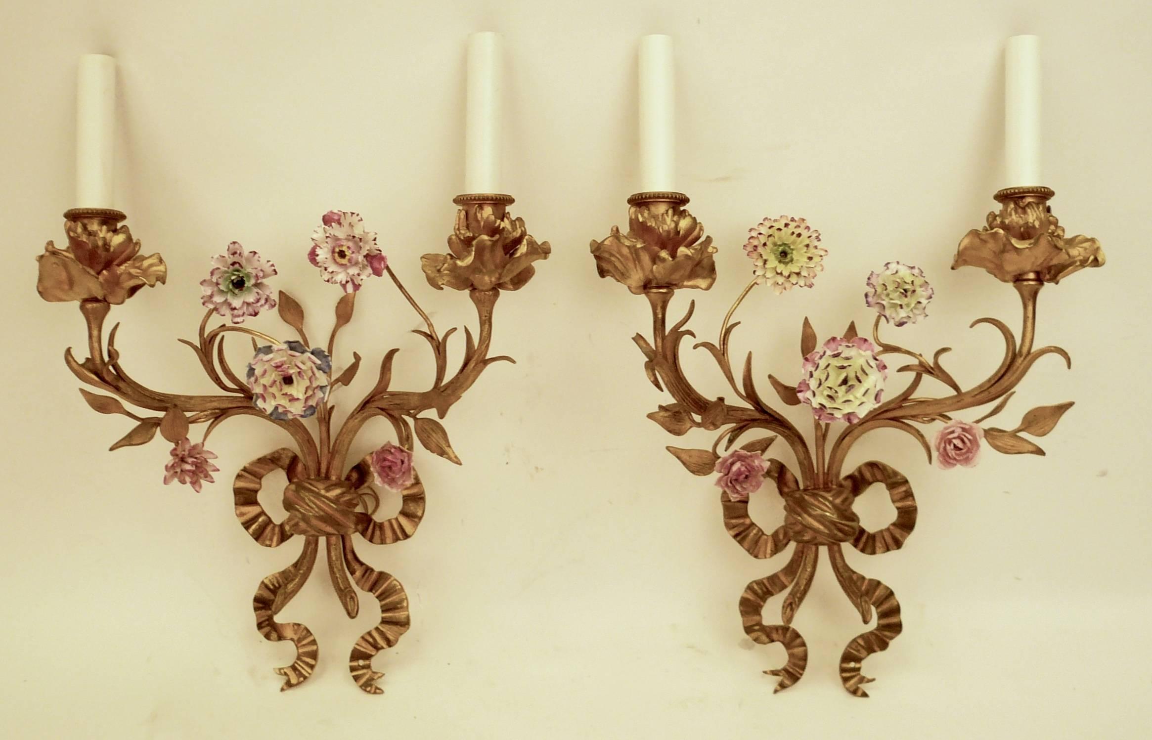 This fine pair of cast bronze foliate, and bow knot motif sconces feature hand-painted porcelain flowers.
They have been newly wired, and ready for use.