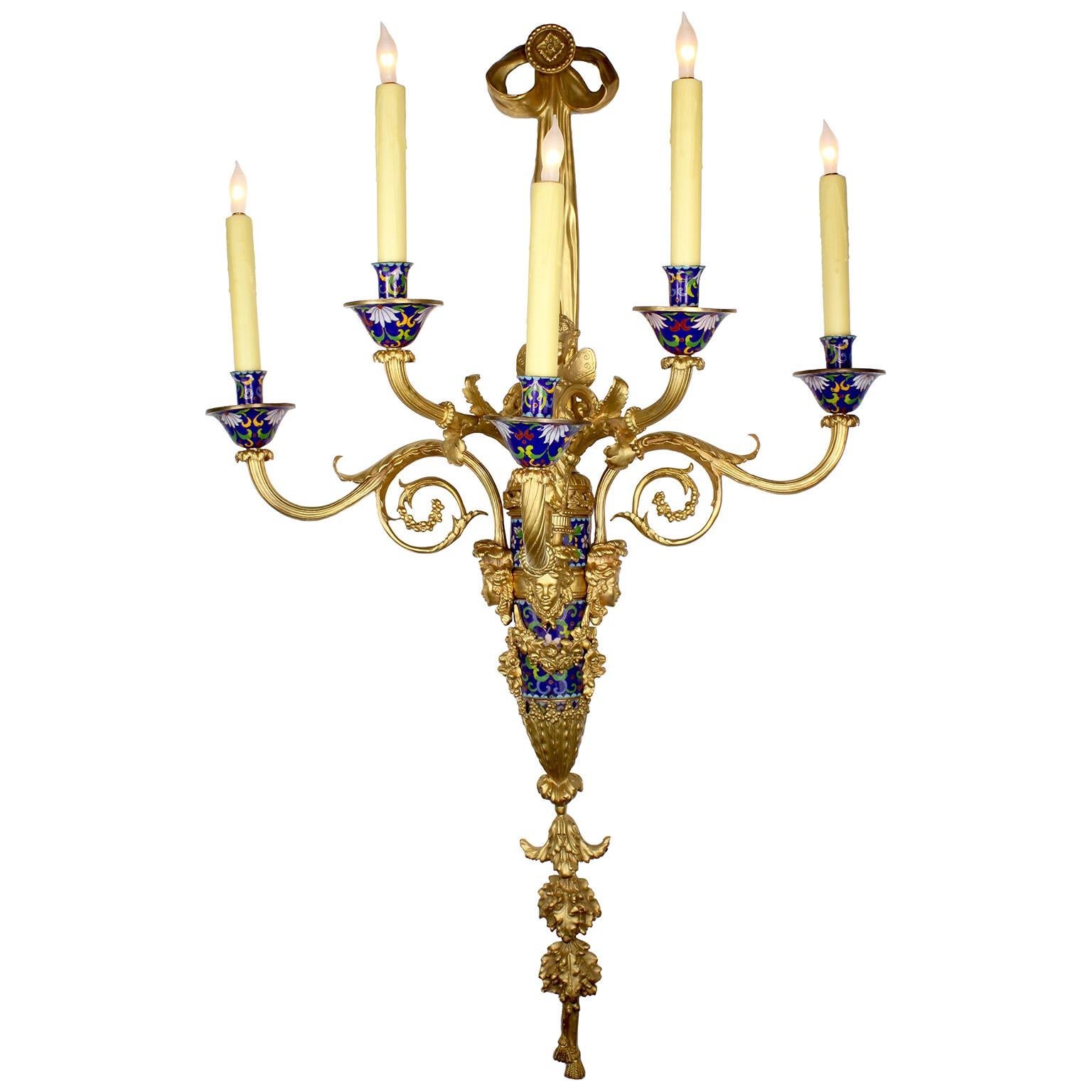 A large and impressive pair of Louis XVI style gilt-metal and champlevé enamel five-light figural wall lights (sconces - appliques) after the model by Pierre-Philippe Thomire (French, 1751–1843). Each sconce with a ribbon-hung reeded and tapering