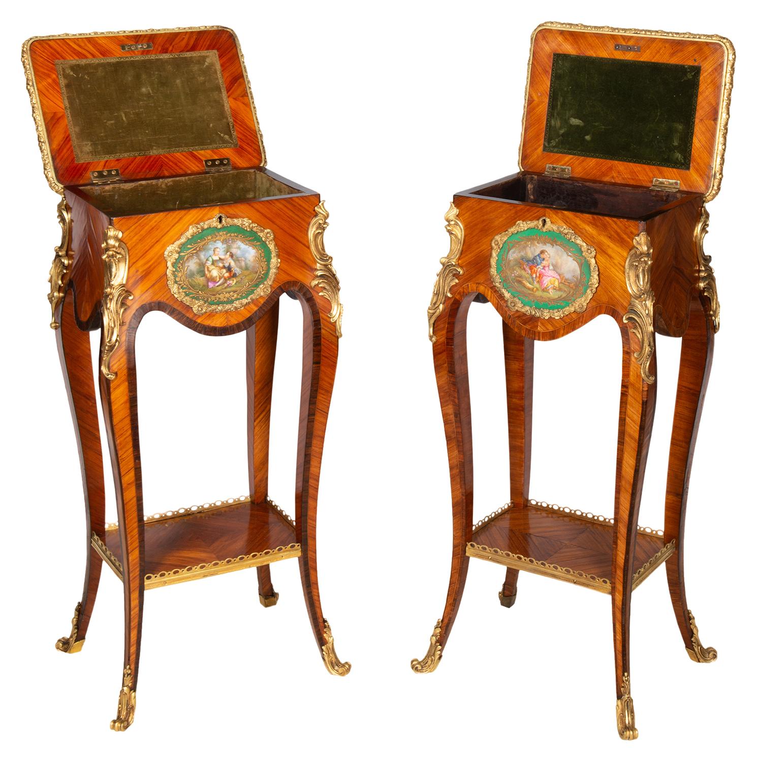 A very good quality matched pair of French Kingwood veneered ormolu-mounted side tables, each with wonderful hand painted Sèvres style porcelain plaques depicting romantic scenes set on a green ground. The lids hinging open to reveal velvet lined