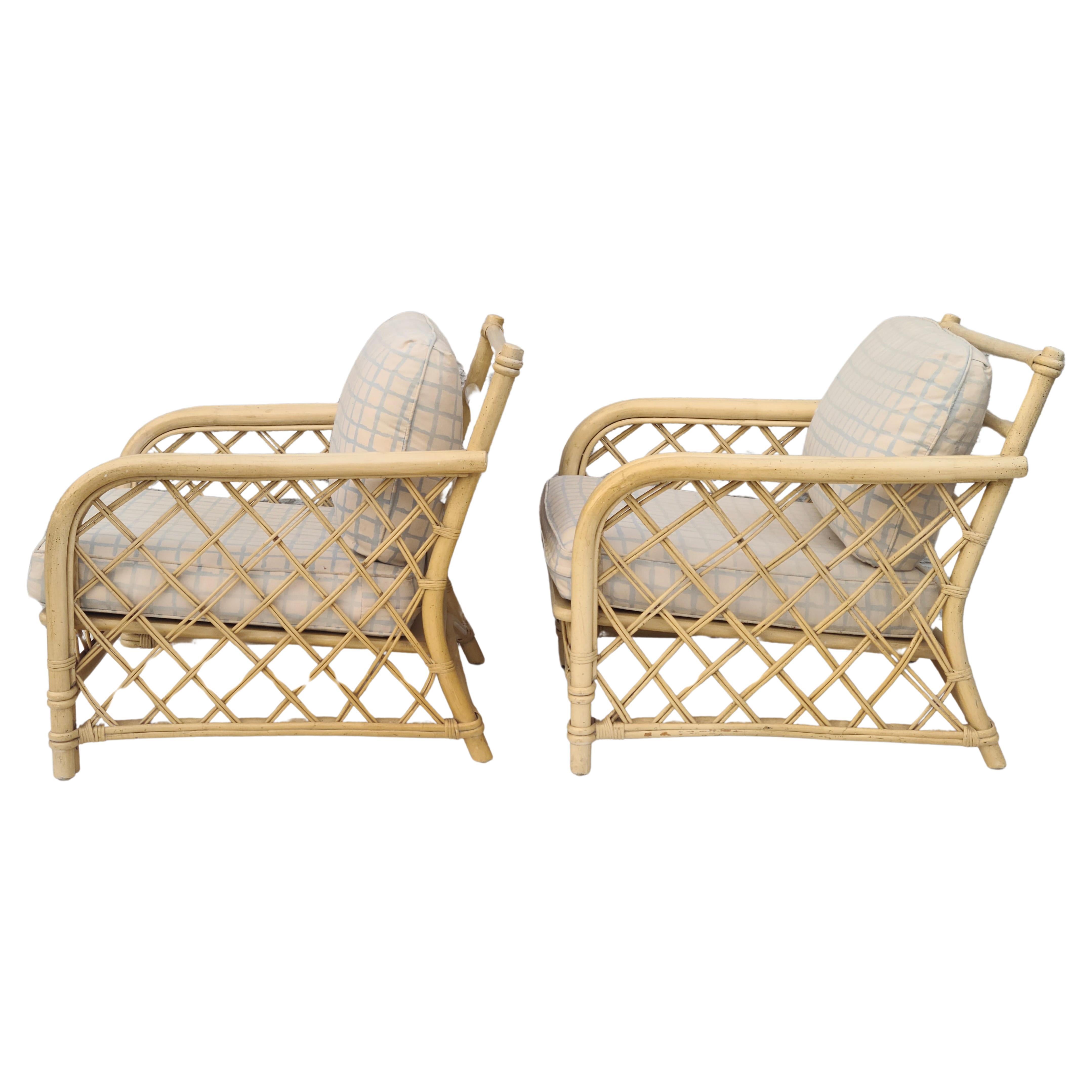 Please feel free to reach out for accurate shipping to your location,.

Pair low lounge chairs by Ficks Reed.
As found condition. New Straps included. 
Frames are solid.
Upholstered cushions for dimensional scale only.
Please feel free to reach out