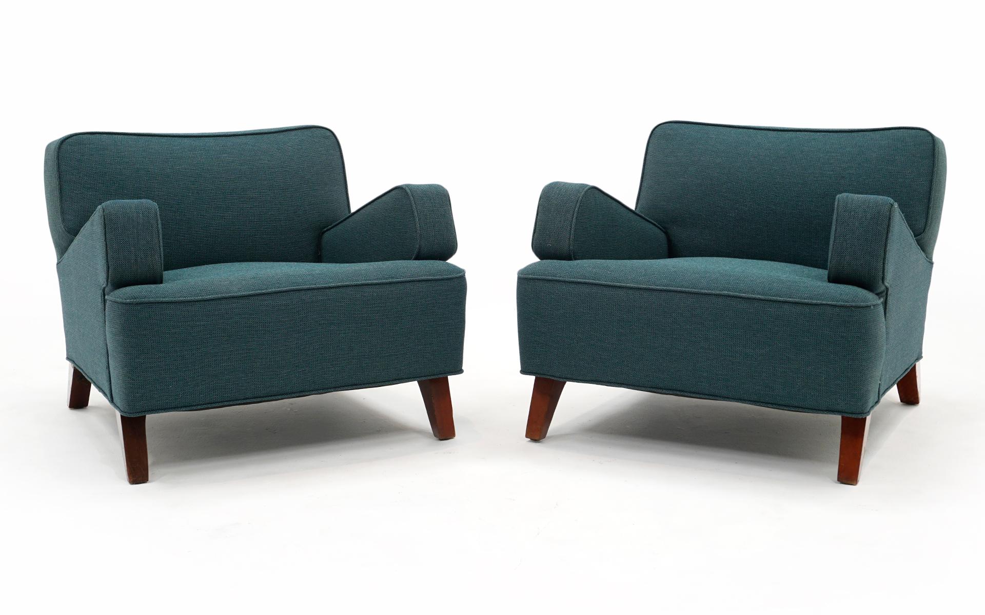Early pair of angle arm lounge chairs designed by Jens Risom. These are one of Risom earliest designs after leaving his position as design director for Knoll. The chairs retain the original blue-green fabric which is free of tears, stains or