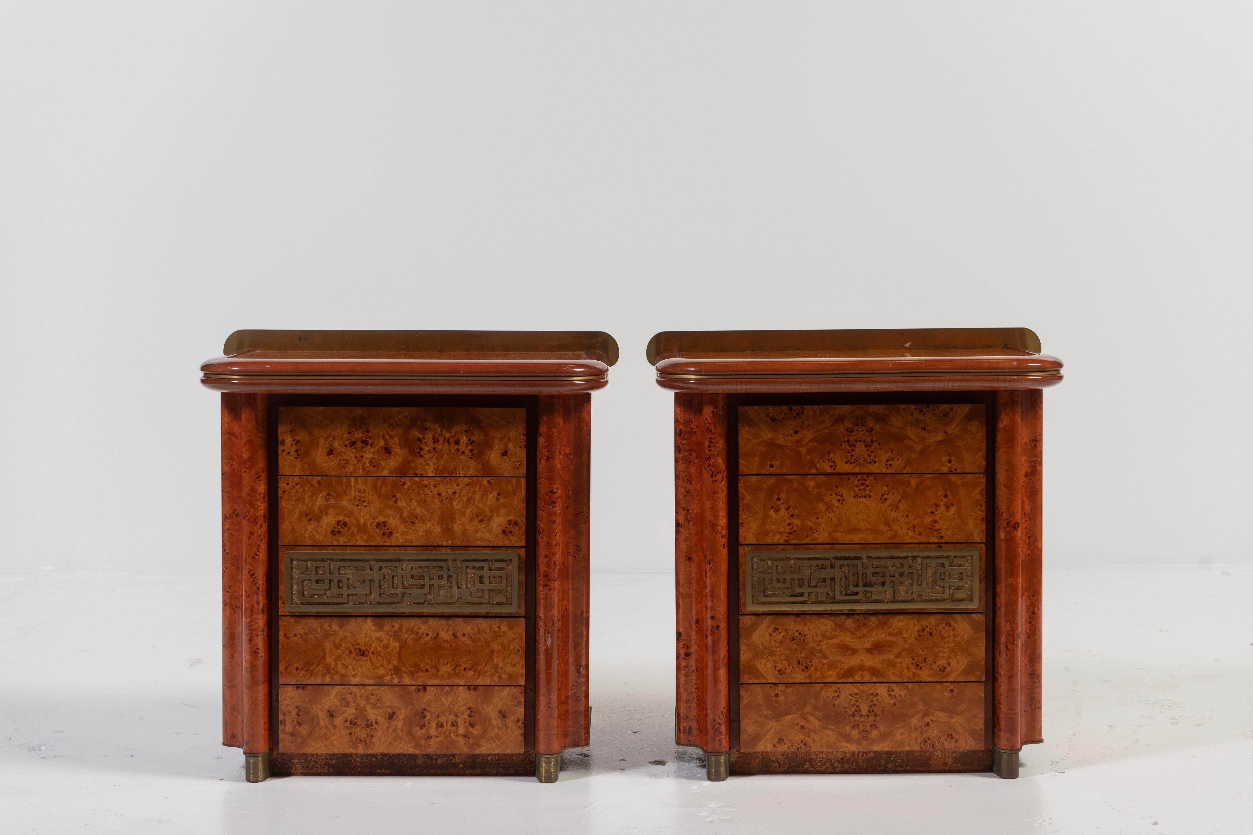 Solid burl, brass and bronze vintage nightstands, by Italian Luciano Frigerio, are listed only as a pair. Beautifully designed with curved edges and intricate metal accents, the pair has five drawers each offering great storage. The surfaces are in