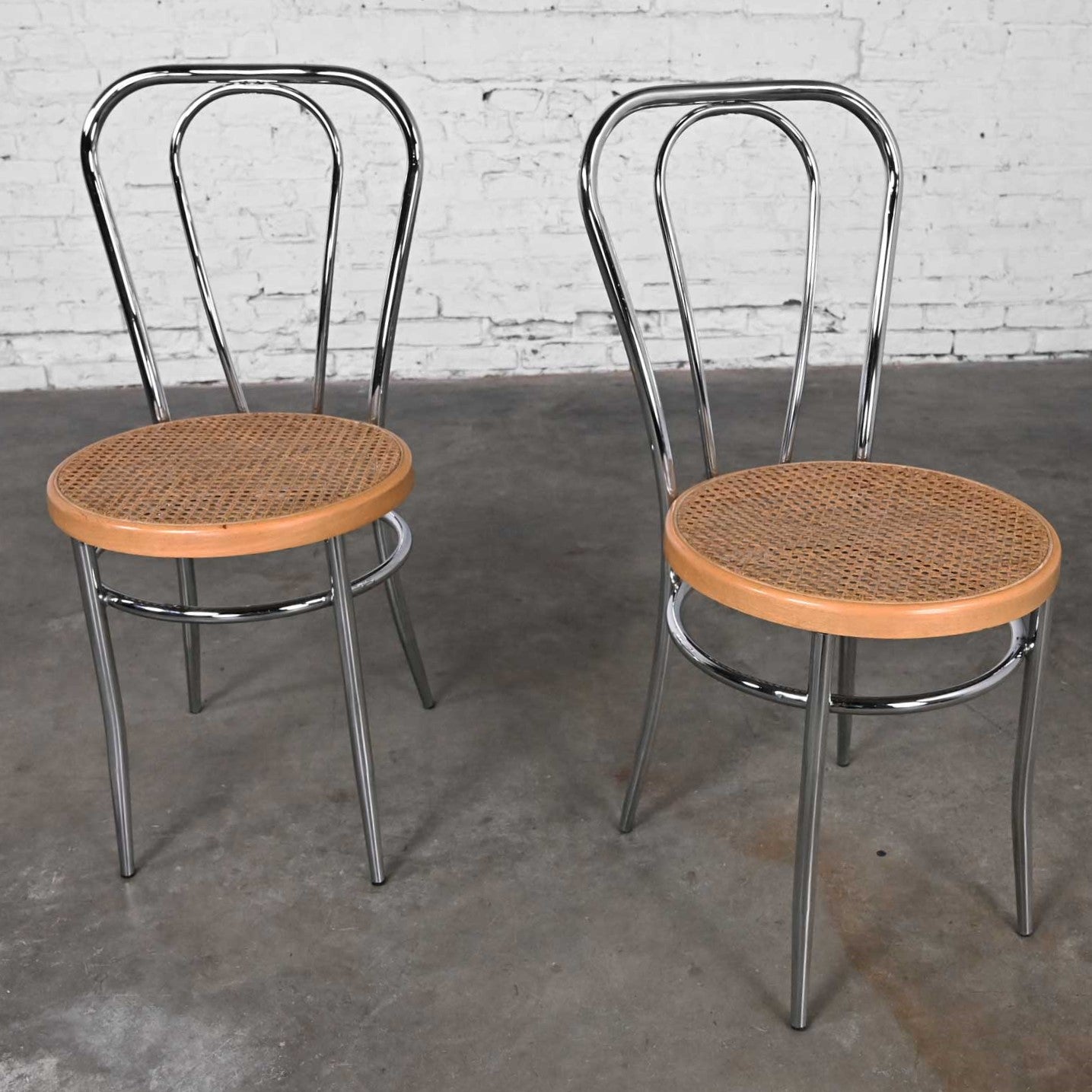 Jolie paire de chaises de bistro ou de café vintage de style Bauhaus fabriquées en Italie d'après Thonet, avec structure chromée et assise en bois et en rotin. Très bon état, tout en gardant à l'esprit qu'il s'agit d'un produit vintage et non pas