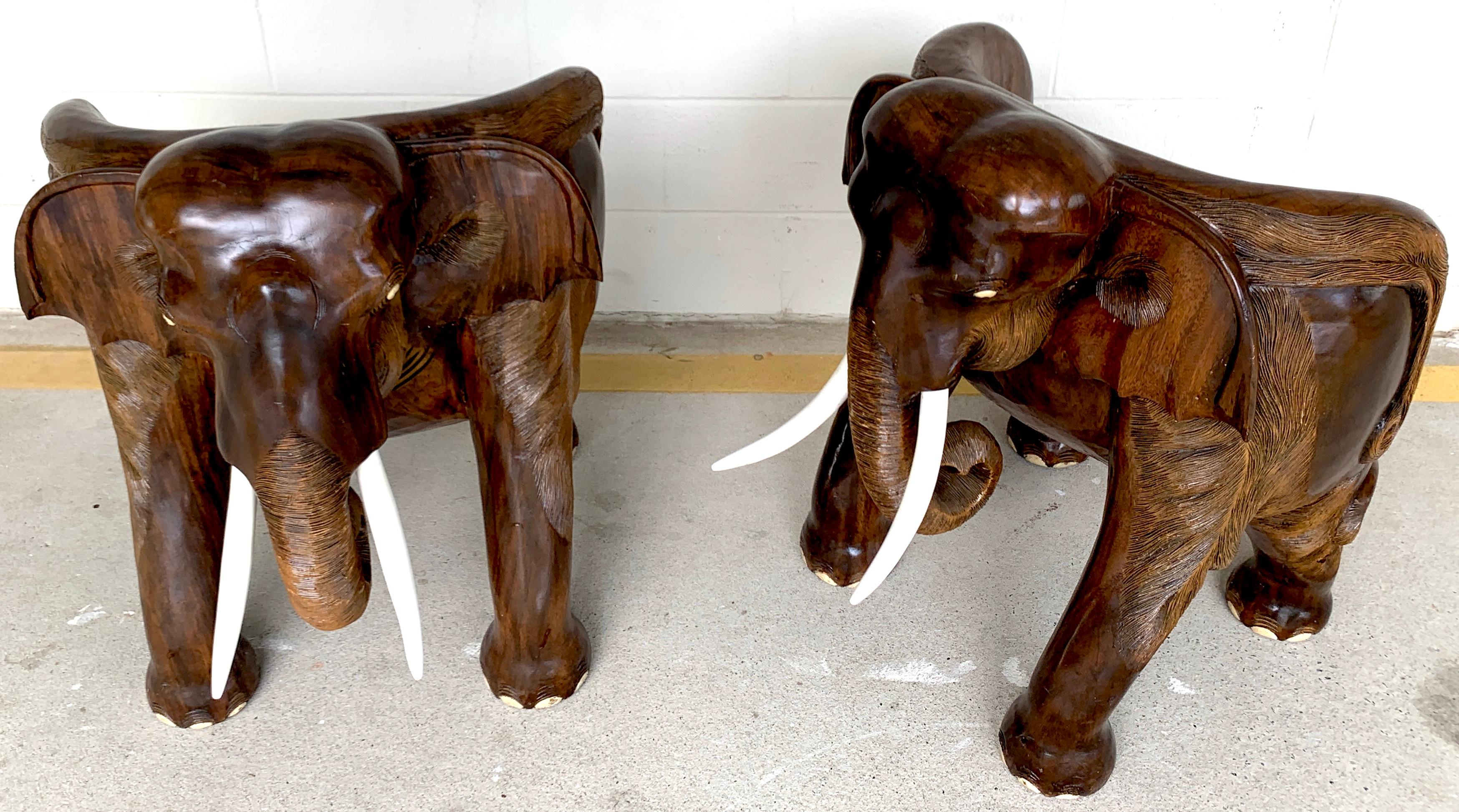 Pair of magnificent of late 19th century hardwood carved elephant chairs
Each one a comfortable, substantial realistically carved, chair, modelled as a standing elephant. The raised back and sides carved as the head and ears, with carved painted