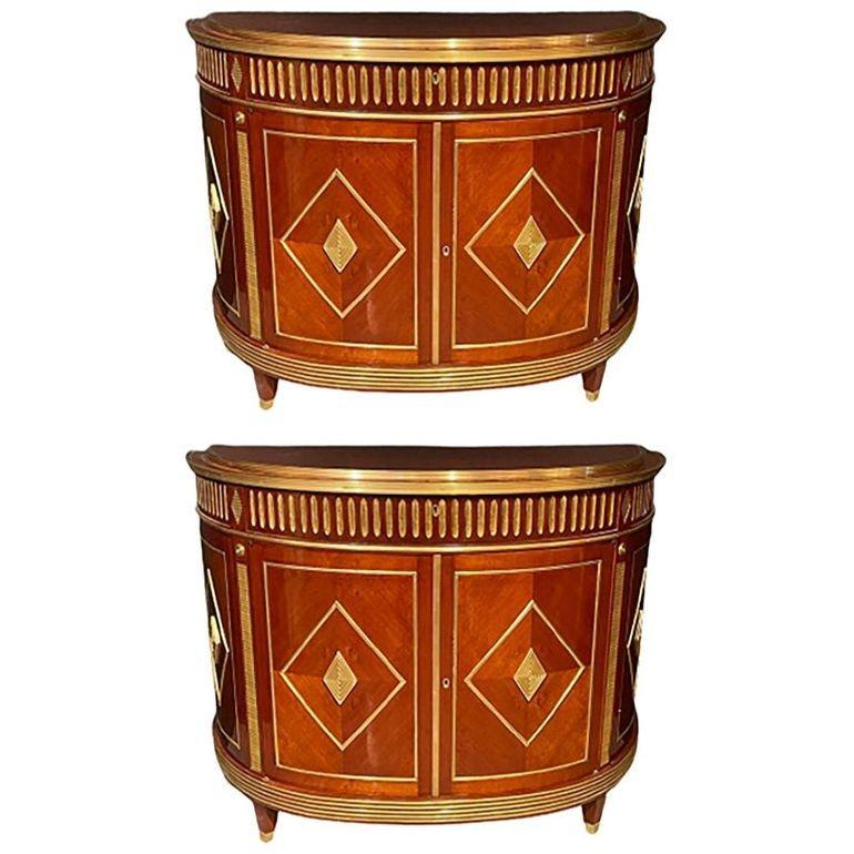 Pair Mahogany Demilune Servers, Commodes Nightstands, Russian Neoclassical, Bnz


This exquisite pair of Russian neoclassical commodes beautifully combines elegance and functionality. The finely polished D-shaped design features open-shelved