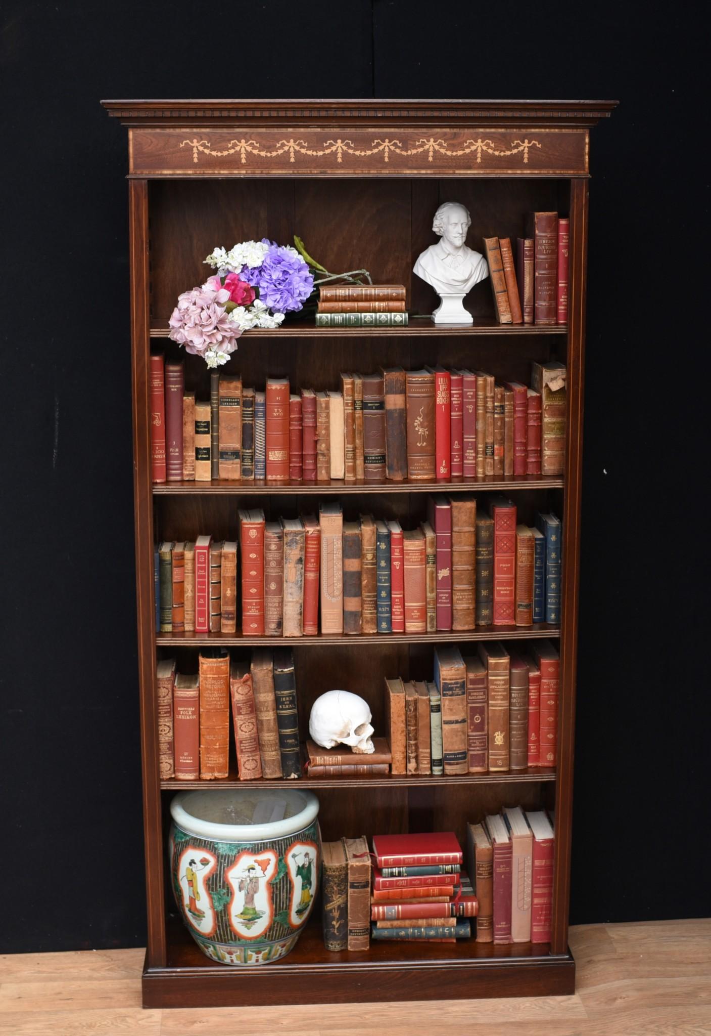 You are looking at a pair of English Sheraton style openfront bookcases hand crafted from the finest mahogany. This lovely pair are the perfect mix of decorative beauty and practical functionality to make for a vintage design classic. They look