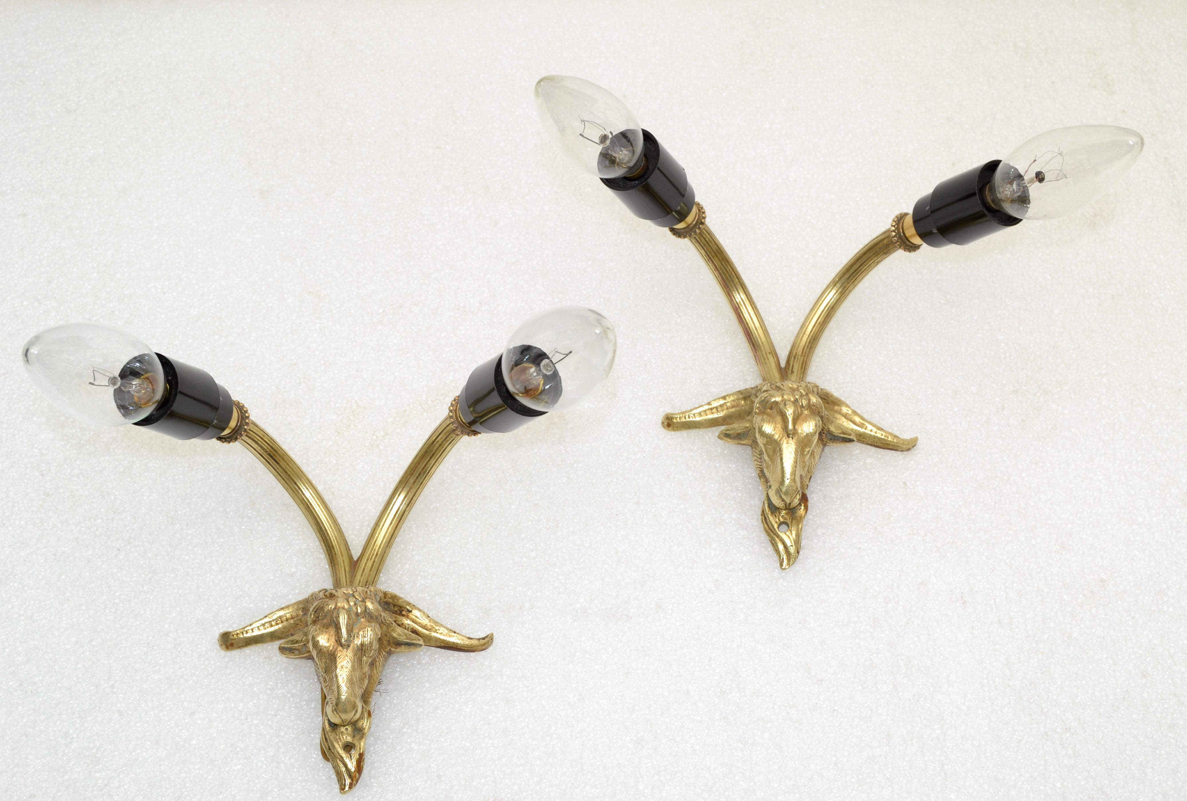 Pair of French Neoclassical 2 lights bronze goat sconces from the 1960.
US Rewiring and each takes 2 candelabra light bulb max. 40 watts.
Back-plate: 1.25 x 3 inches. Junction box cover in 5 inches diameter available for an additional