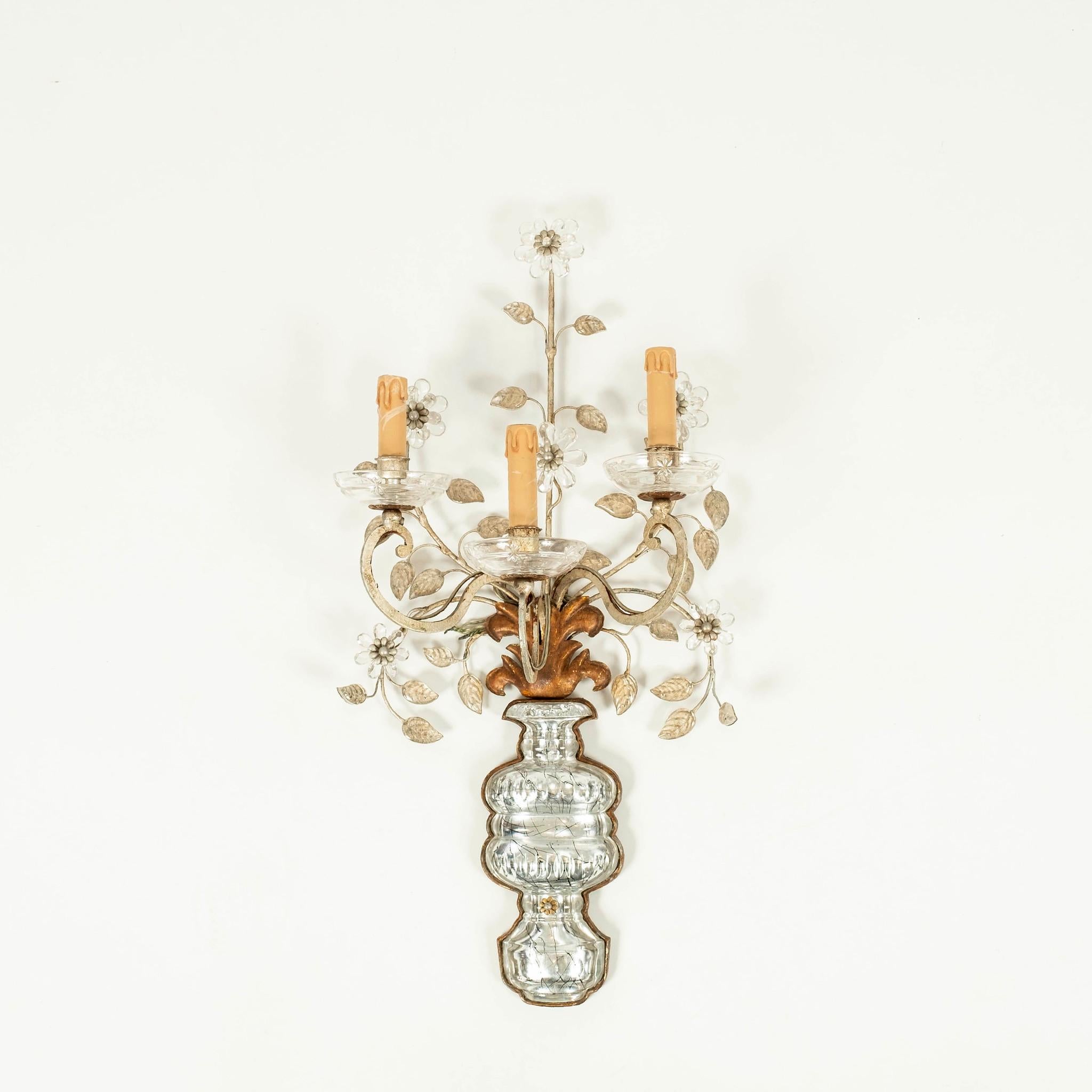 Pair of three arm gilded Bagués style rock crystal sconces showcasing a lovely floral and foliage plumage with vase.