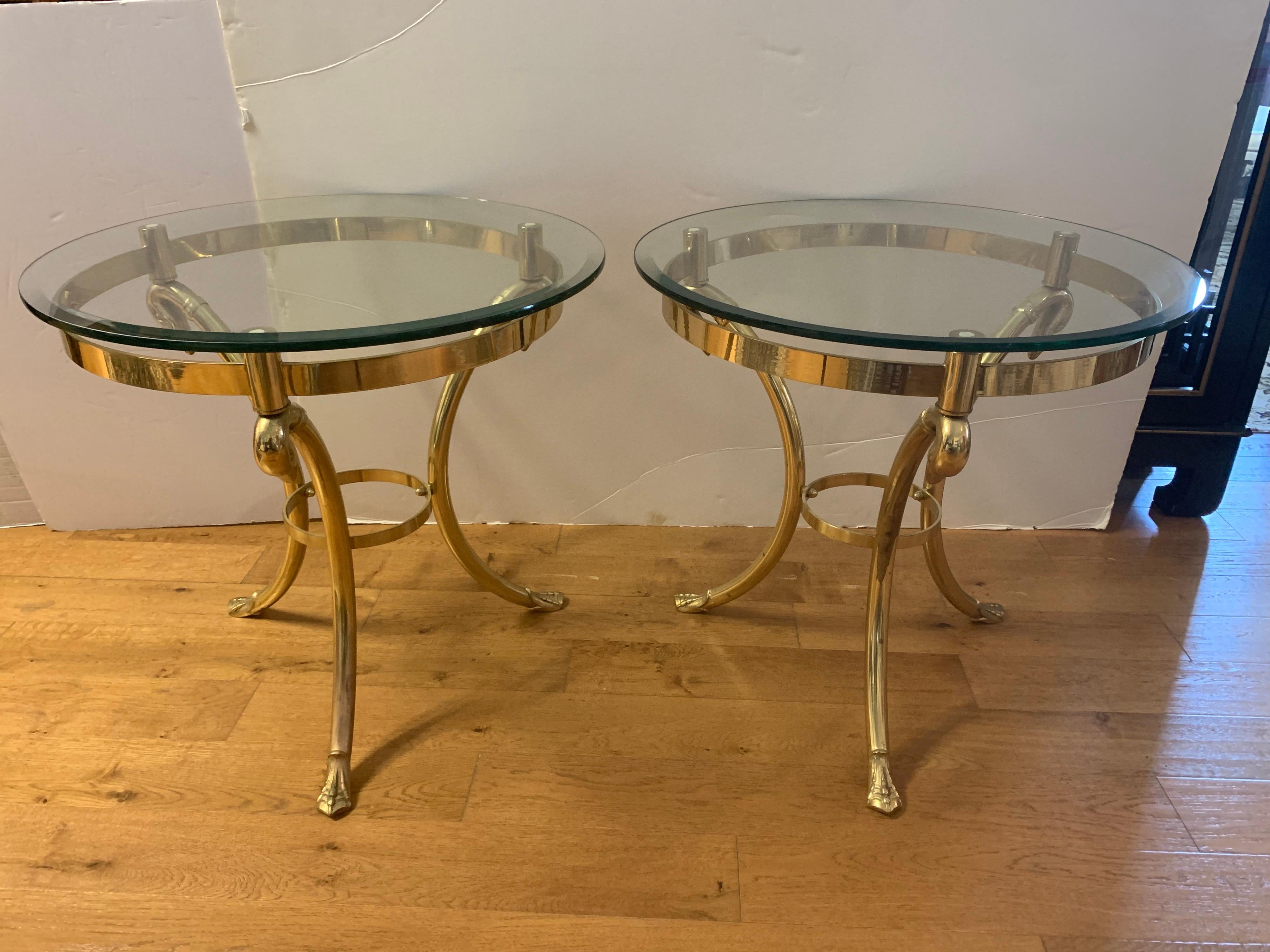 Two elegant Maison Jansen mid-century neoclassical end tables, gueridons or nightstands with beveled glass tops and three legged brass base with swan heads and feet.