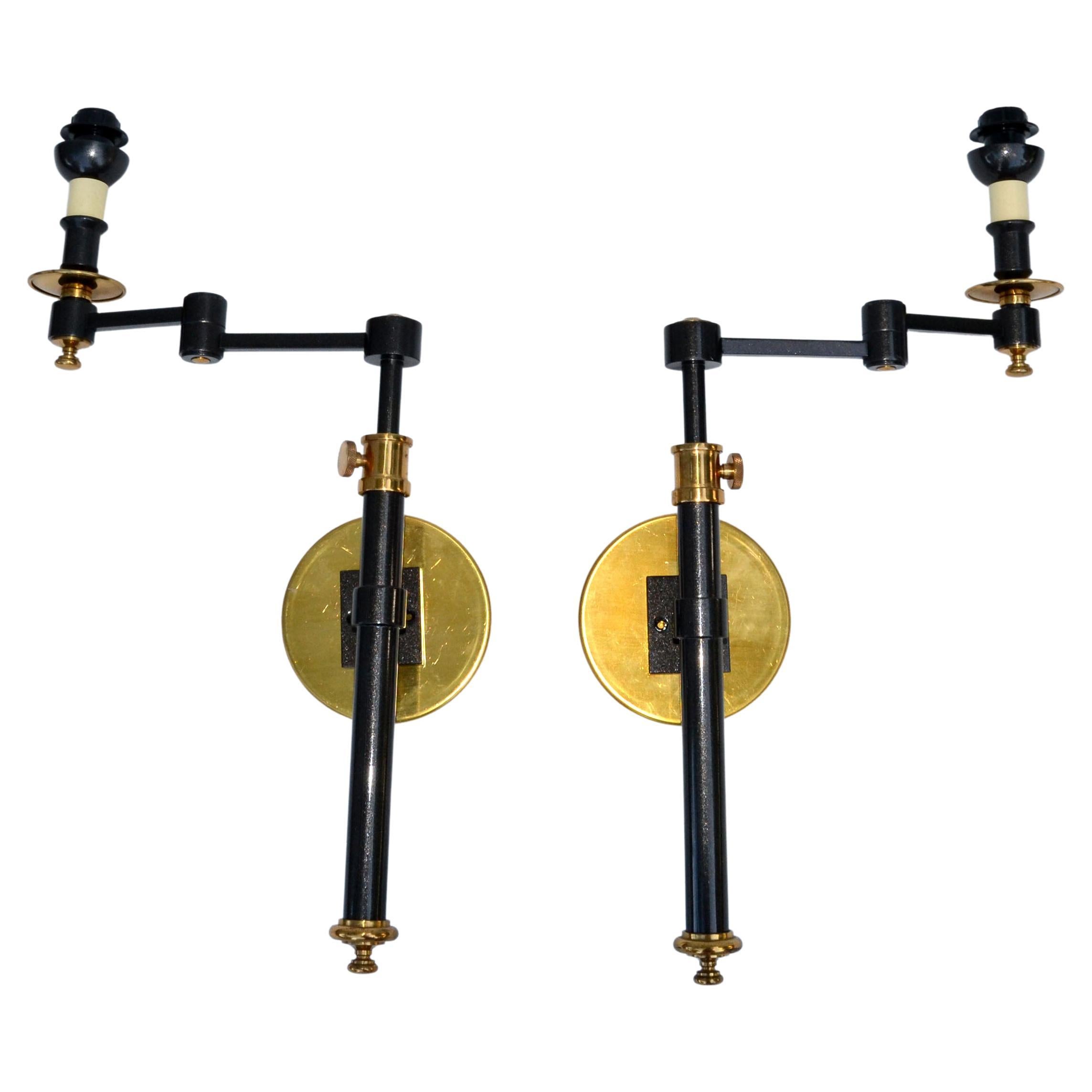 Very elegant pair of brass retractable Maison Jansen style sconces France with drum shade in black & gold.
Wired for the US, each sconce takes one light bulb with max. 60 watts. 
Measurement: max projection to the wall 14.75 inches