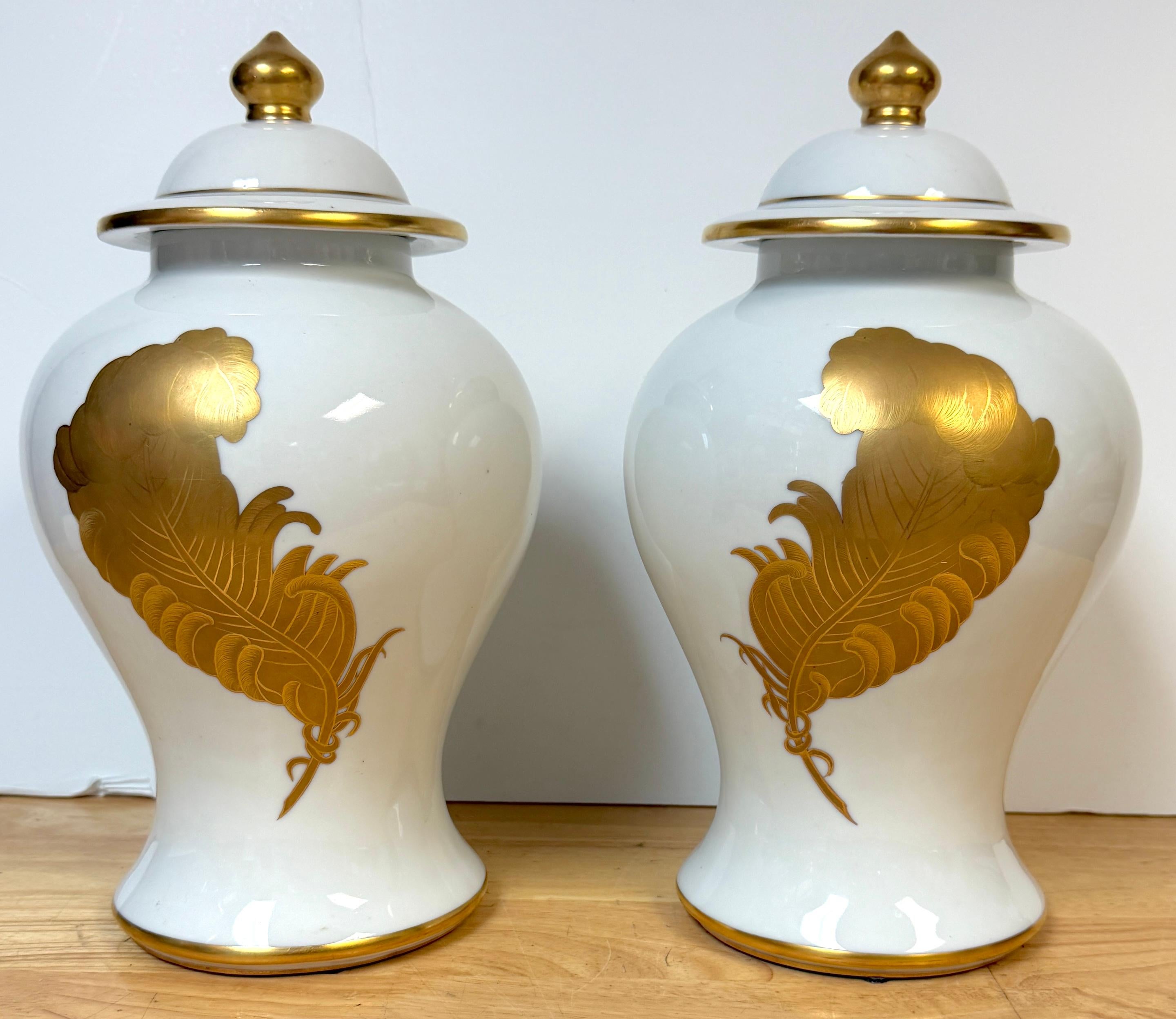 Pair of Maison Jansen–Style Porcelaine de Paris Covered Urns with Gilt Feather Decoration, France, c. 1940–1960
The set consists of four pieces two lids and two vases 
Dimensions: 13