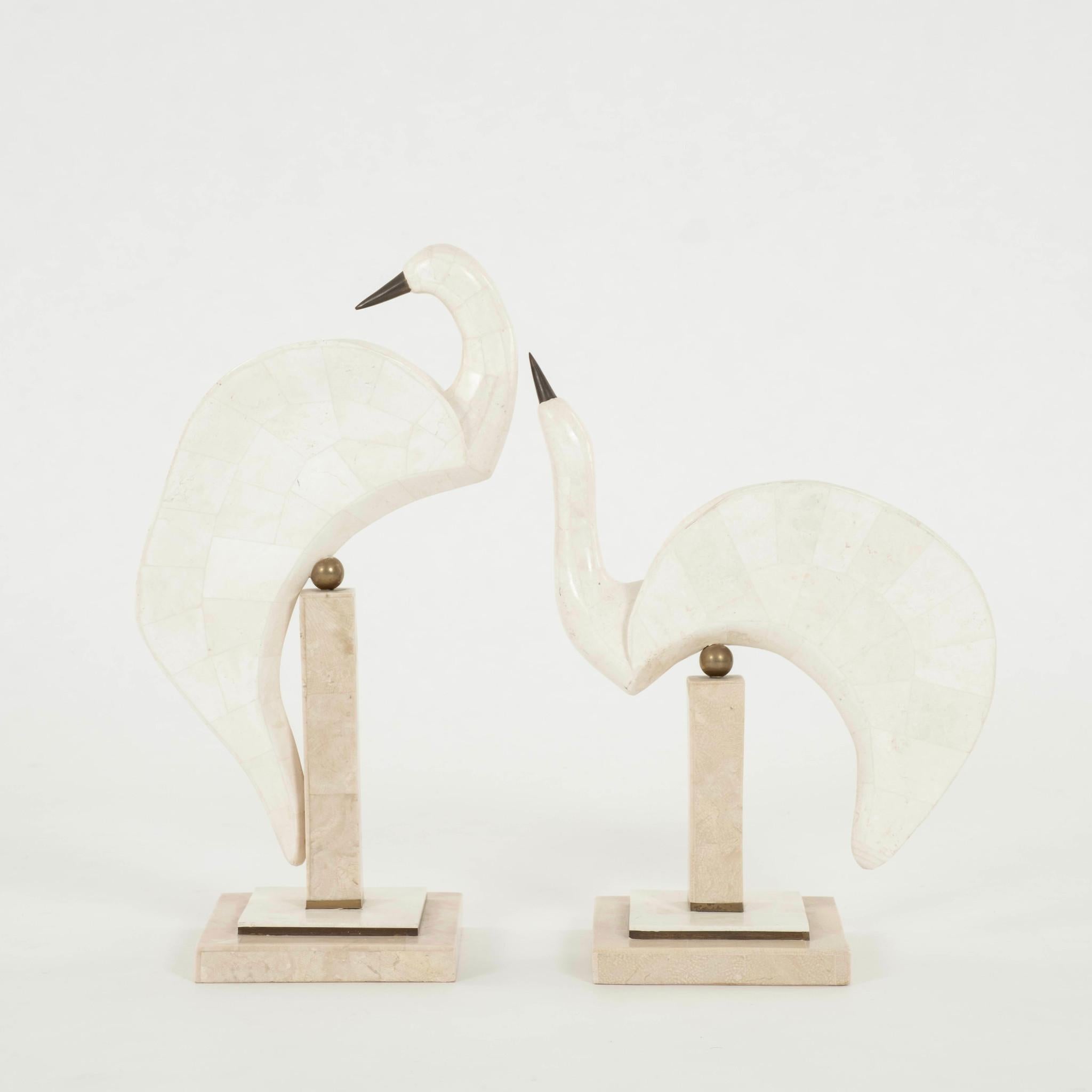 Pair of contemporary mixed travertine stone egret or heron bird sculptures. Each bird is meticulously crafted with tessellated stone and brass.

DIMENSIONS:
Larger Piece 20.25