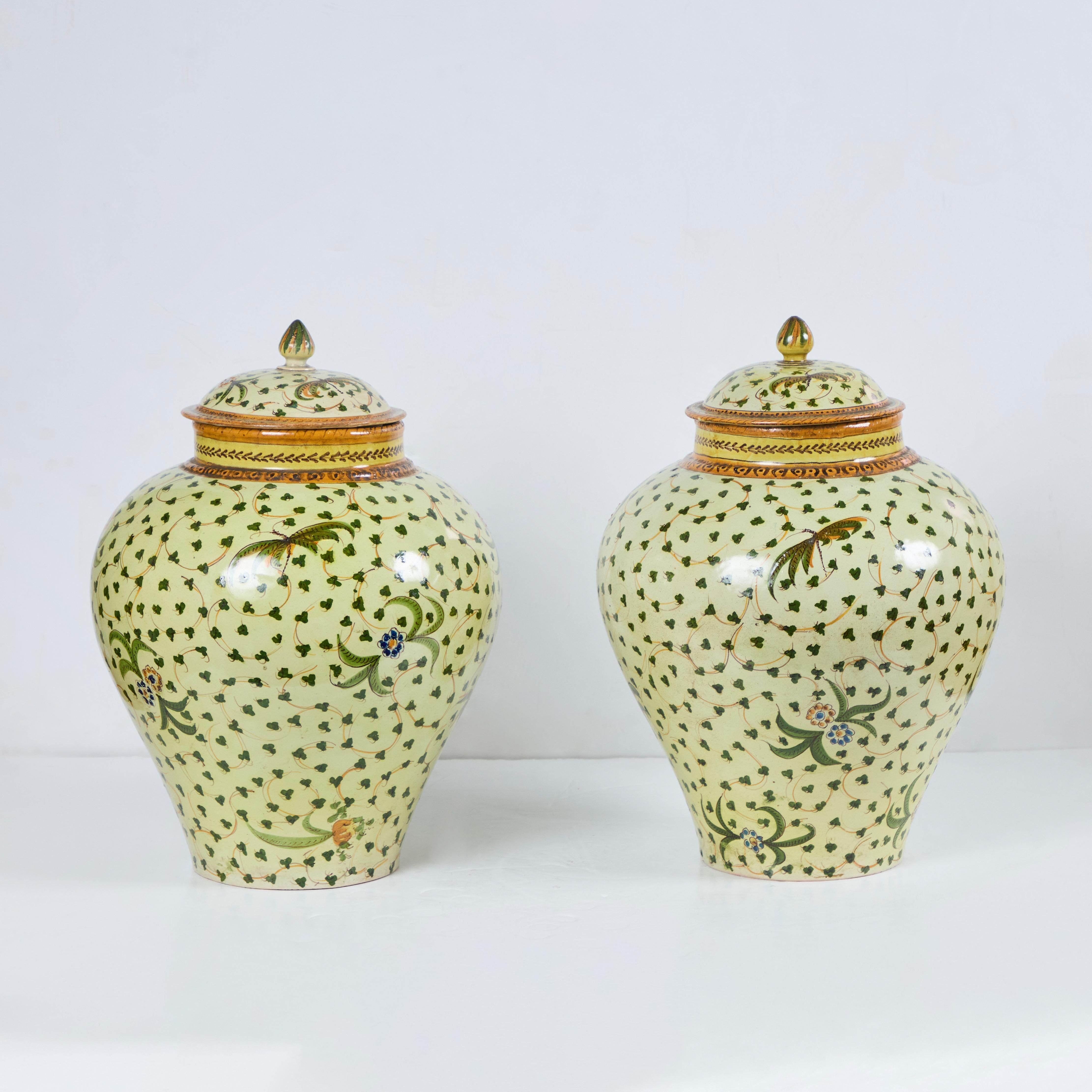 A charming pair of hand-painted Majolica pottery covered jars.