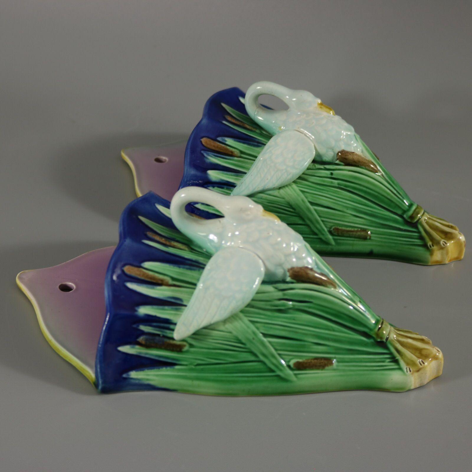 Pair of Adams and Bromley (attributed) Majolica wall pockets which feature swans amongst cattails/bulrushes. Colouration: cobalt blue, green, white, are predominant.