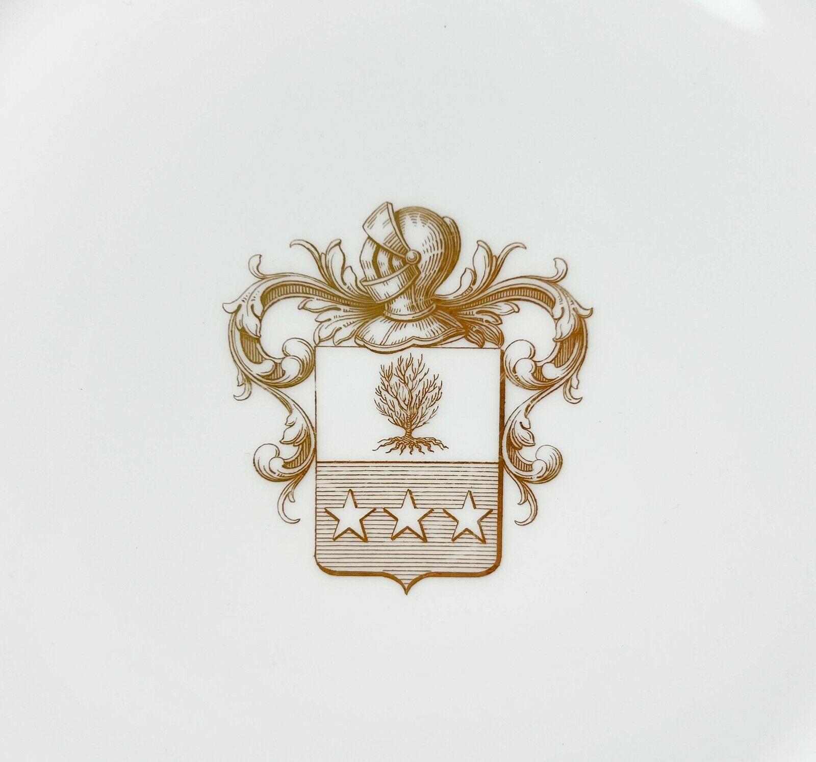 Pair Manufacture de Sevres Gilt Armorial Porcelain cabinet plates, 1859 & 1860

A white ground with gilt coat of arms to the center featuring a helmet with foliate scrolls, a tree within a shield with three stars. Gilt to the rim and foot. Sevres