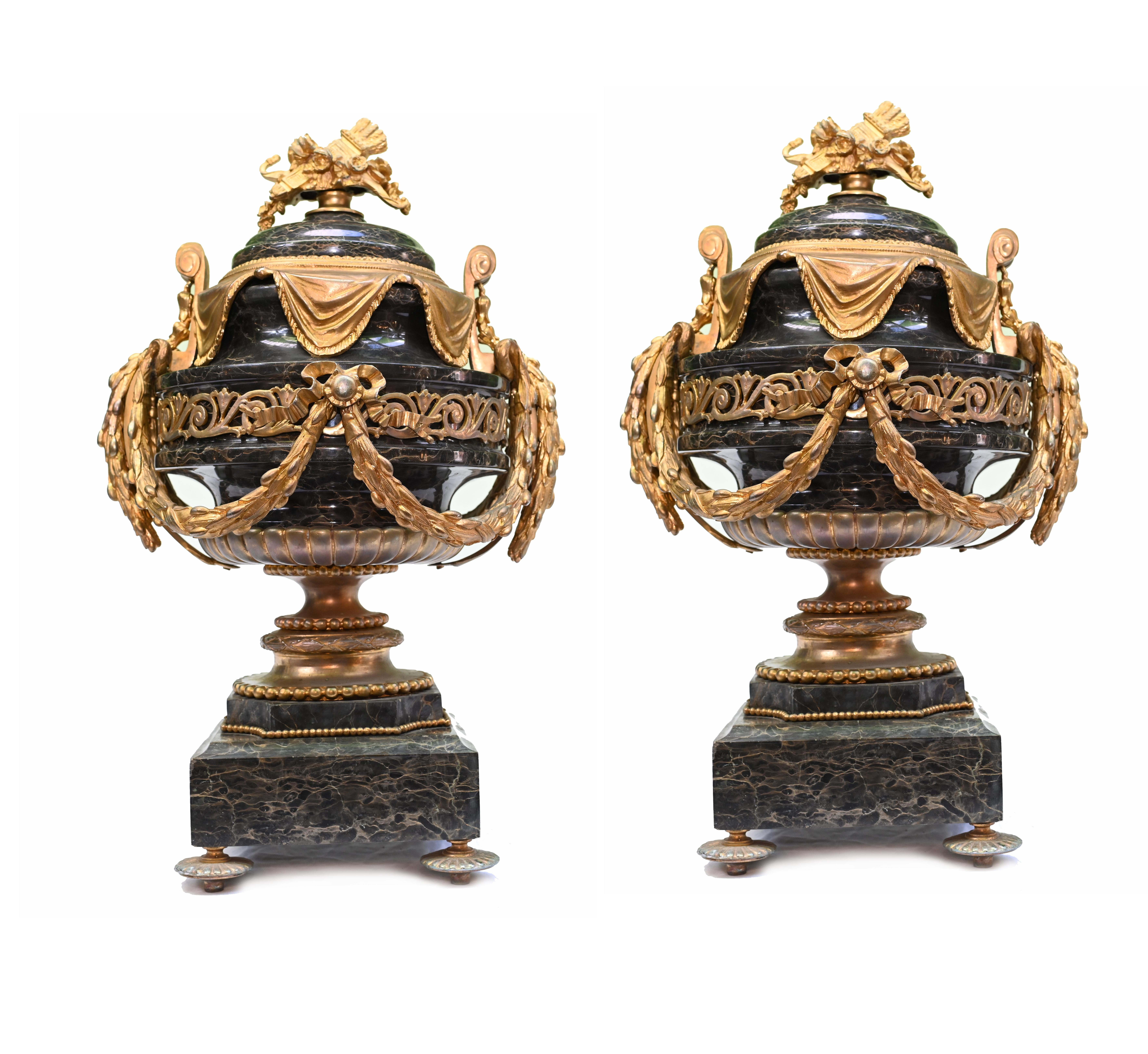 Mouth watering pair of French Empire marble cassolettes
The stone is black Portoro marble with such a beautiful grain and all smooth and chip free
The ormolu mounts are very well cast including sashes, drape motis and wheat sheaf finial
Circa 1880