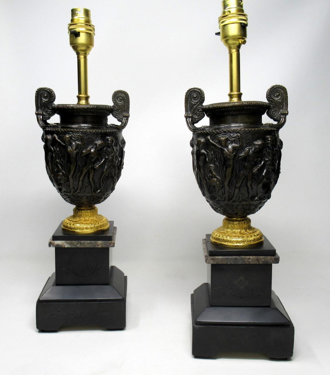Stunning pair of solid bronze electric table lamps of good size proportions, the main central support is a model of the Townley vase cast in relief ending on an ornate ormolu spreading socle, terminating on a square black and grey marble stepped