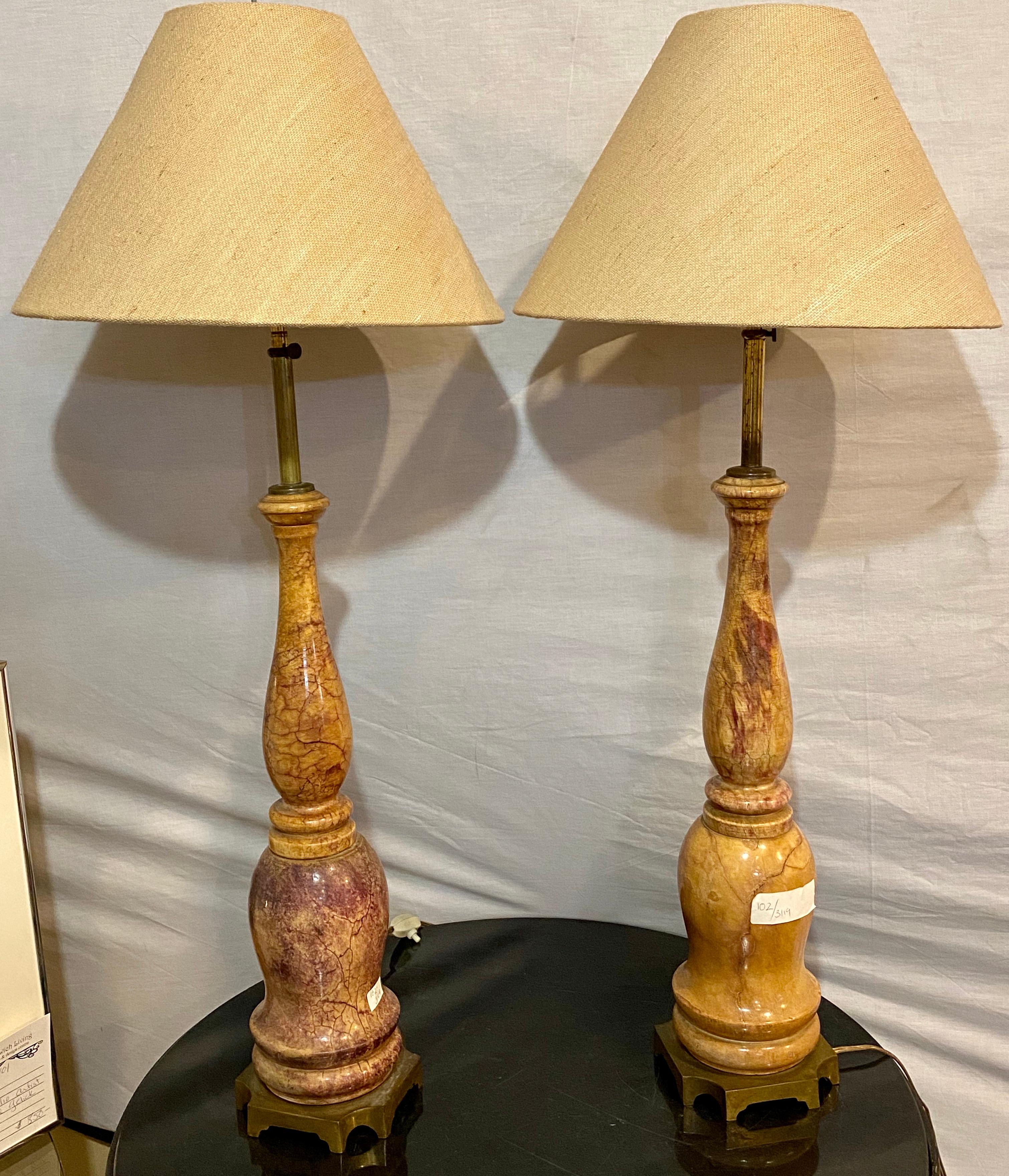 Pair of marble table lamps Hollywood Regency style with original shades.
Missing one finial. Small chip on one lamp as seen in photos.