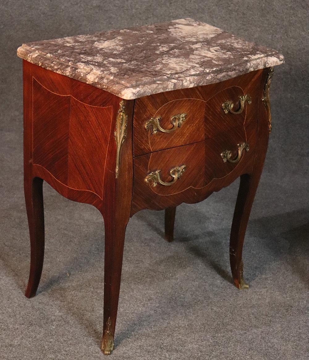 This is a beautiful pair of French antique 1930s nightstands. The stands are in good condition and have their original finish and no damage to the marble and no issues with regards to the cases. This is a nice pair and probably something you've been