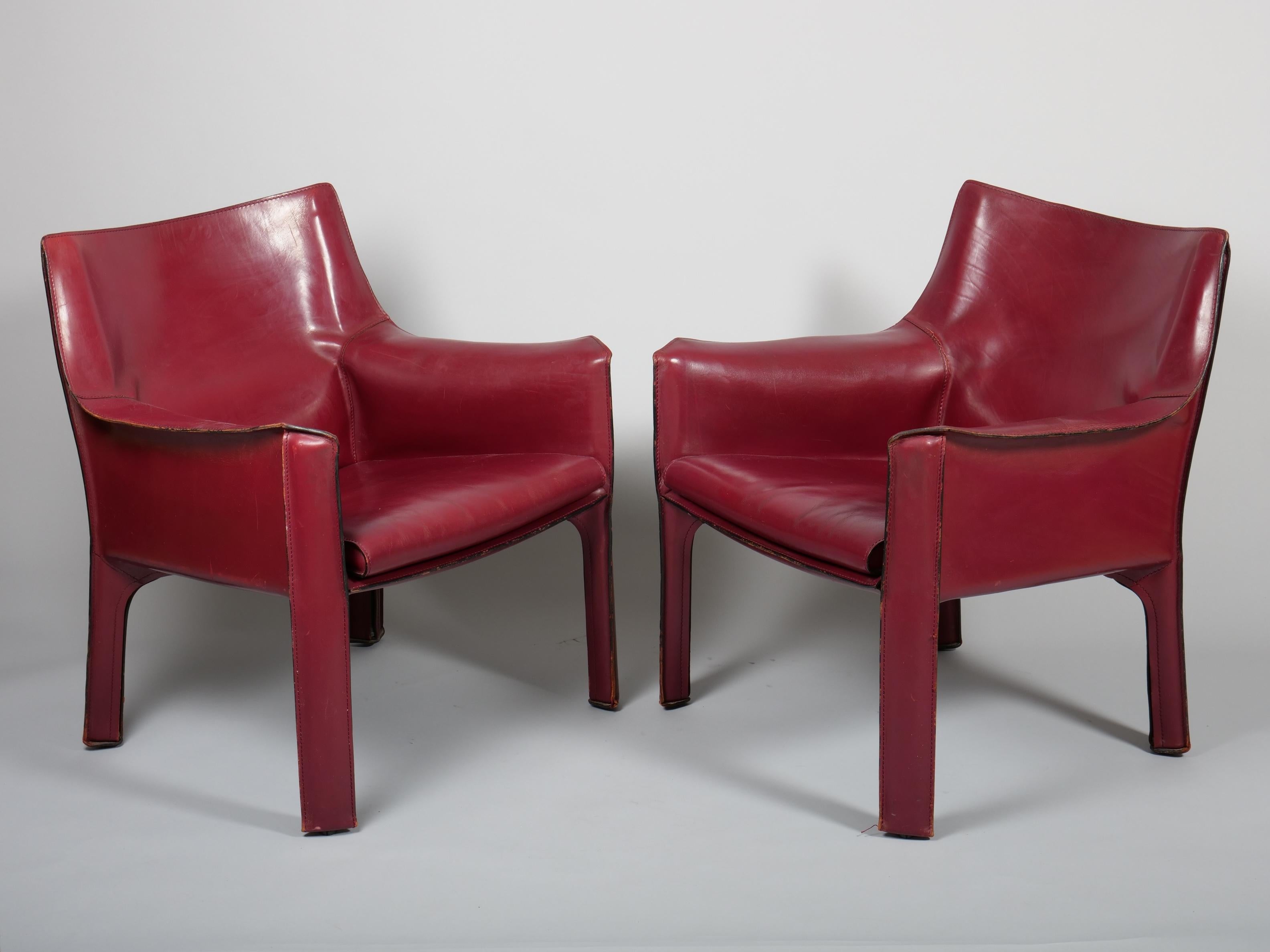 A pair of Mario Bellini armchairs. Model 414. For Cassina

These are the medium sized of the armchair variant. 

The chairs are a thick stitched leather which is made to zip over the steel frame.

The seat is cushioned for a very comfortable seat!

