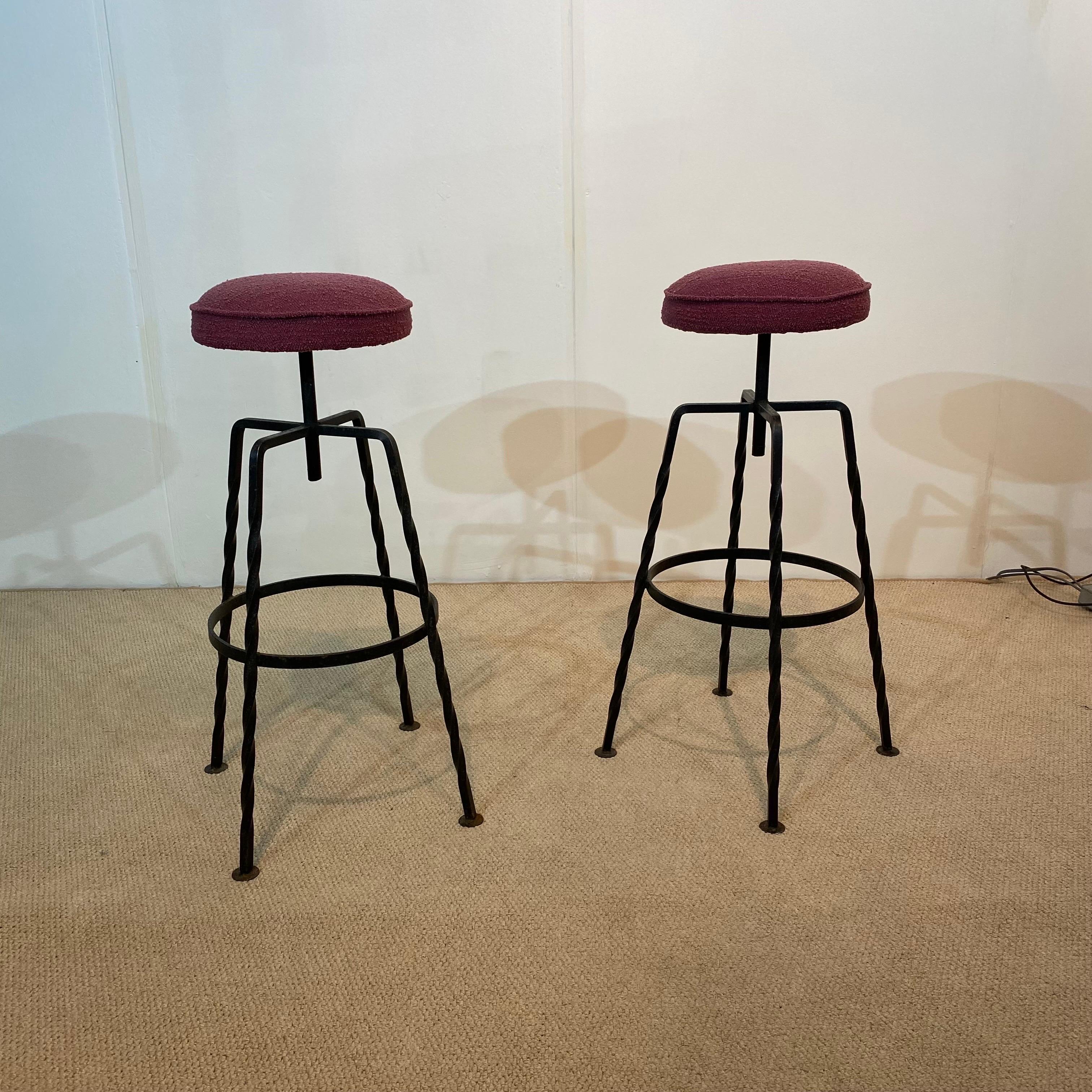 An elegant pair of bar stools, with a strong iron base topped with a round newly upholstered wool bouclé seat. The wool bouclé is from the prestigious The Isle Mill of Scotland, and is made from organic wool, coloured with a natural dye. Four stools