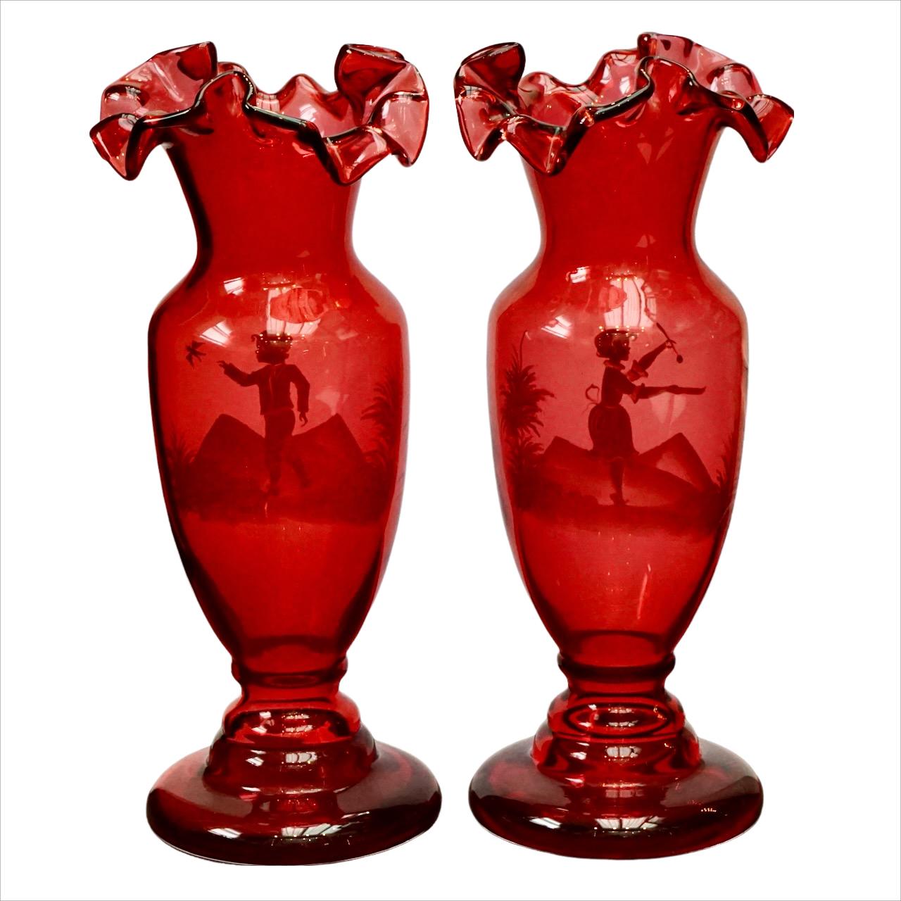 Beautiful Mary Gregory pair of hand painted cranberry glass fluted vases. The vases are hand made. Measuring height approximately 28 cm / 11 inches, and the base is diameter 10.6 cm / 4.17 inches. The vases are in very good condition.

These