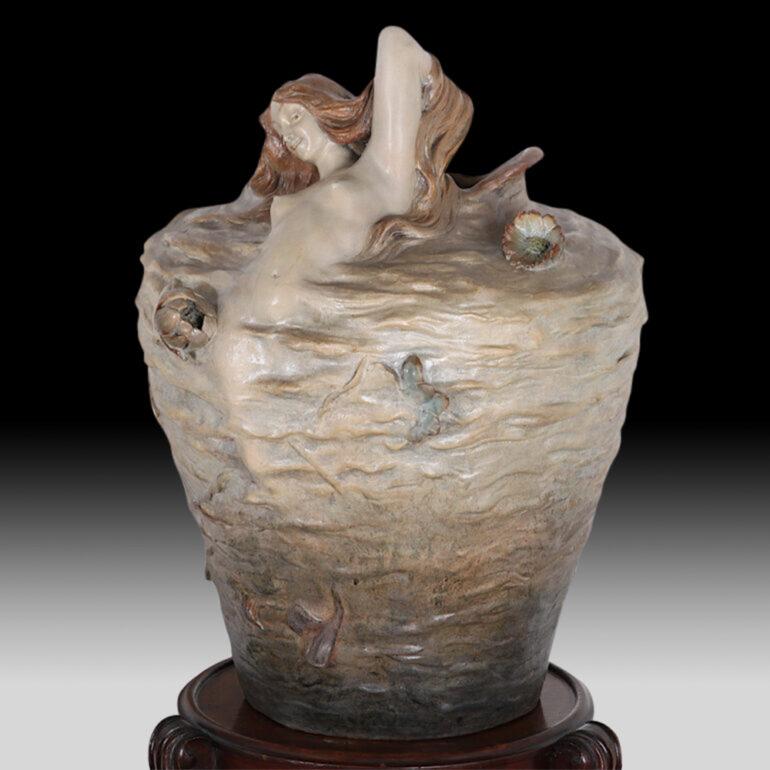 Very rare pair of massive matching Art Nouveau terra cotta vases by Friedrich Goldscheider of Vienna, featuring sensual Siren or Mermaid figures emerging from rippled waters C. 1900.



  