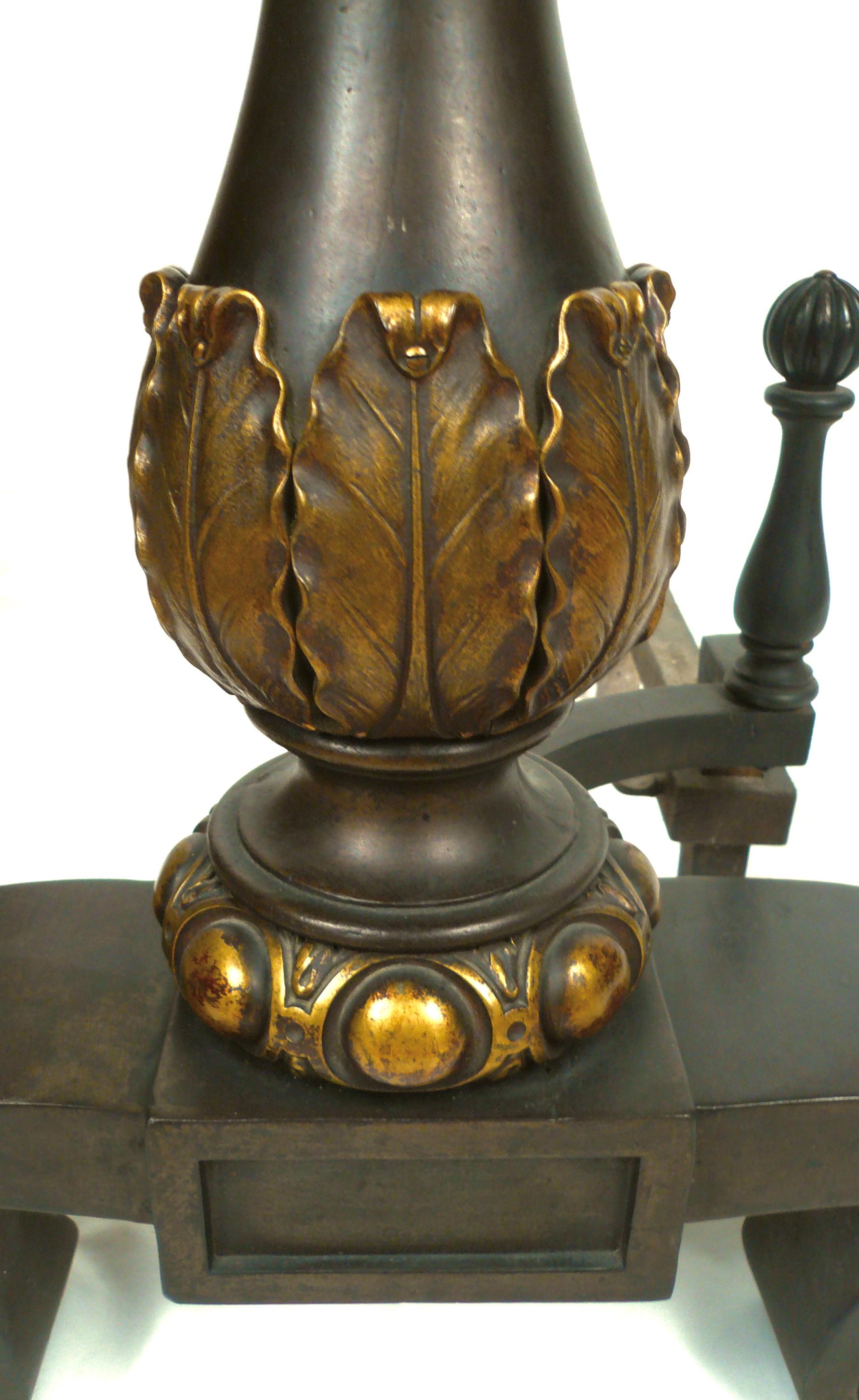 This pair of classic Georgian style andirons are baronial in scale, and feature baluster form uprights with egg and dart and acanthus leaf details.