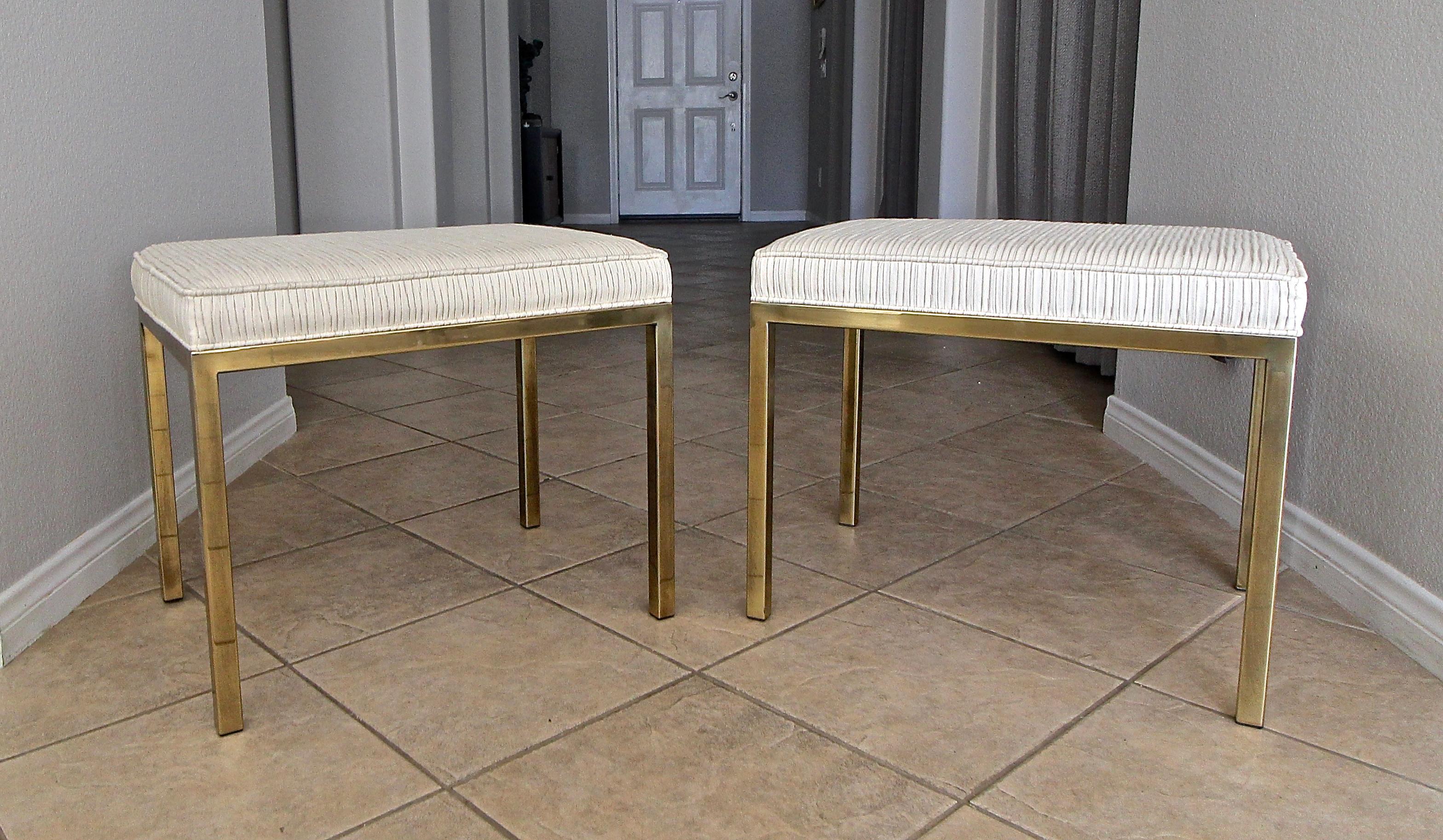 Pair of Mastercraft antiqued brass finish rectangular shaped benches or stools with newer off white pleated upholstery.