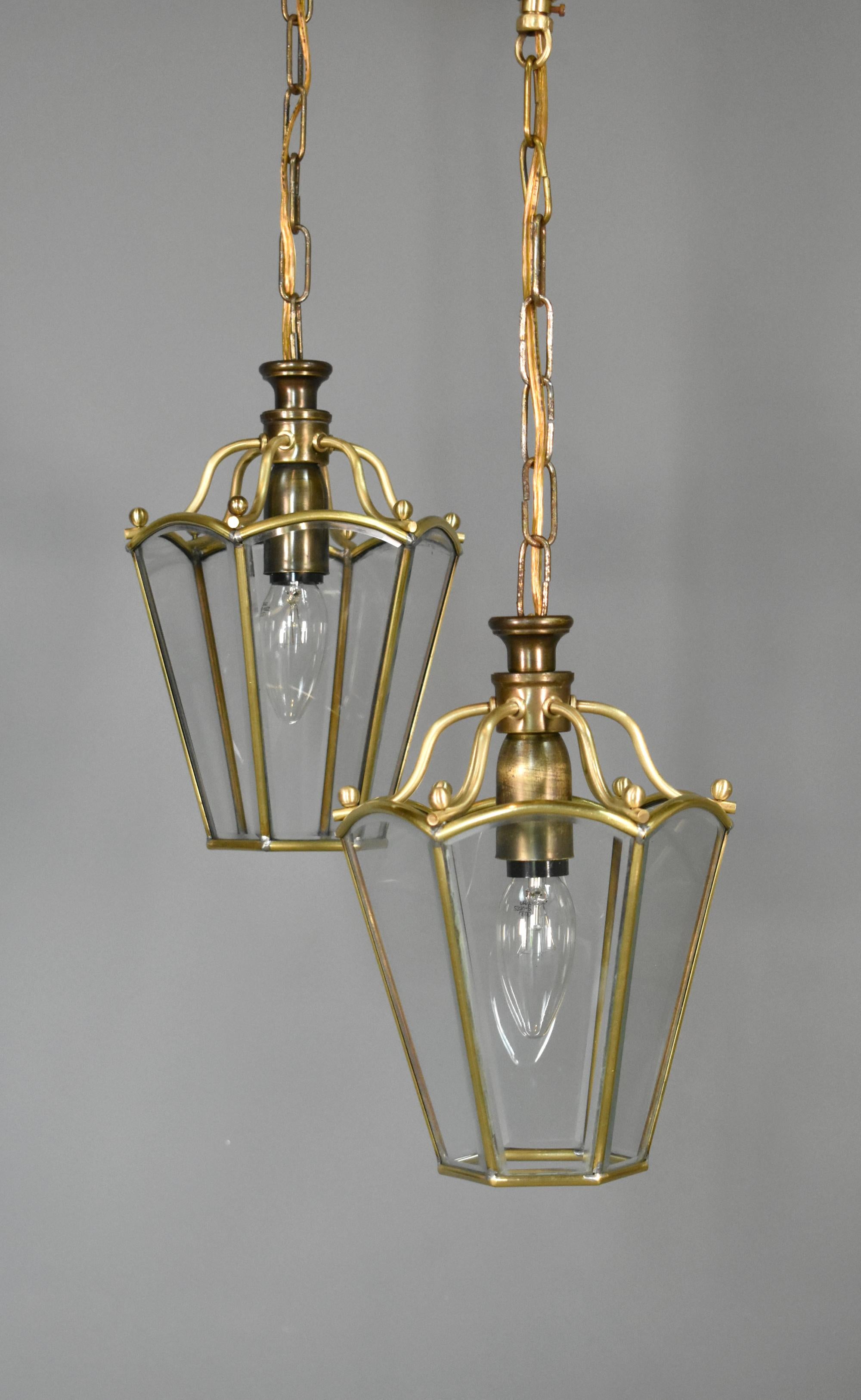 Pair Matching Brass Lanterns
 
An attractive pair of small hexagonal hanging lanterns with clear bevelled glass panels held within a polished brass frame.
 
In excellent condition, these classically styled lanterns would bring a touch of elegance