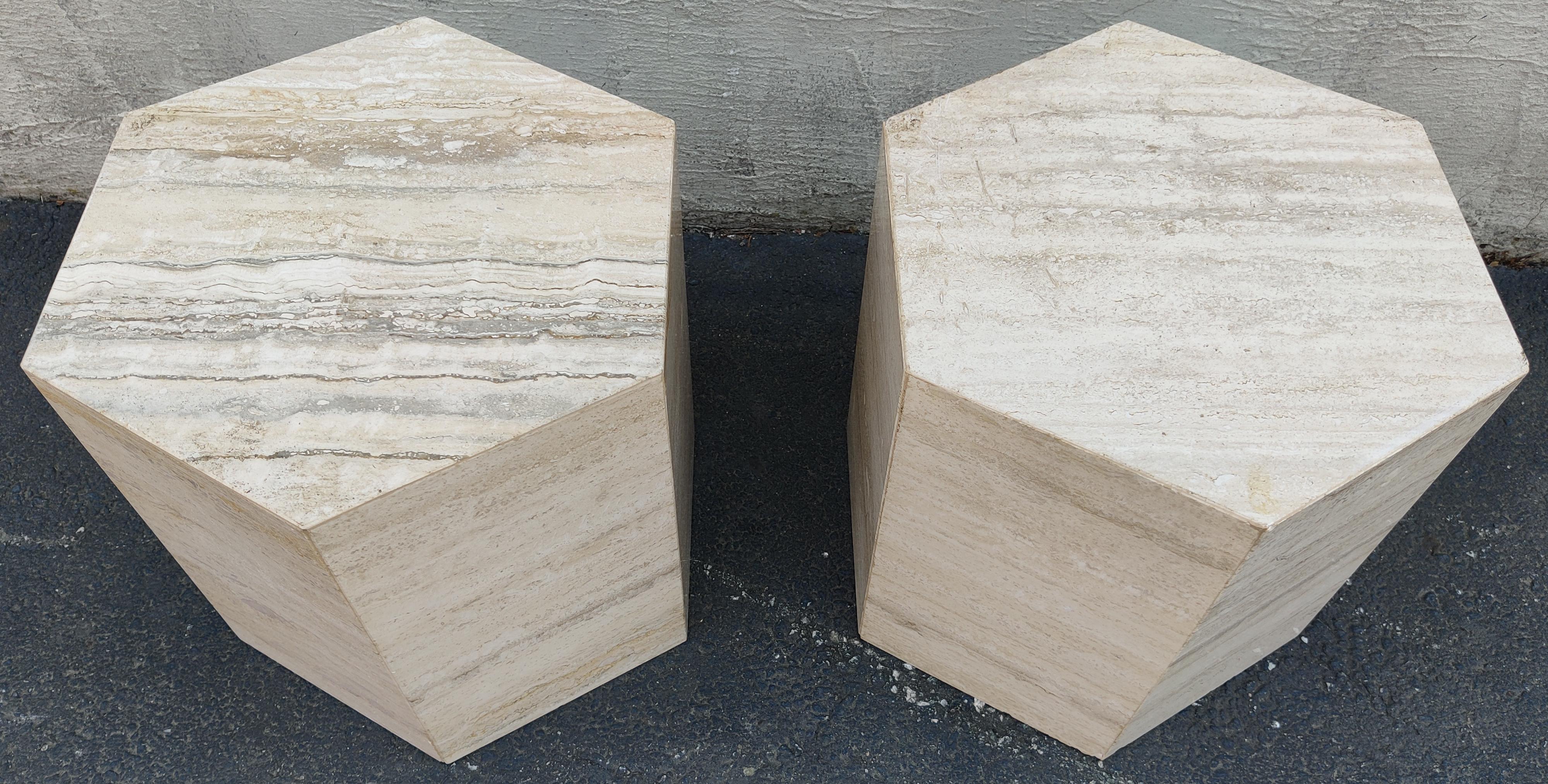 Pair of Italian travertine marble haxagonal side tables or pedestals. The polished travertine is beige and cream colored with beautiful variation. Notice in some areas the grain develops a red or rust-colored hue, which adds to its beauty and