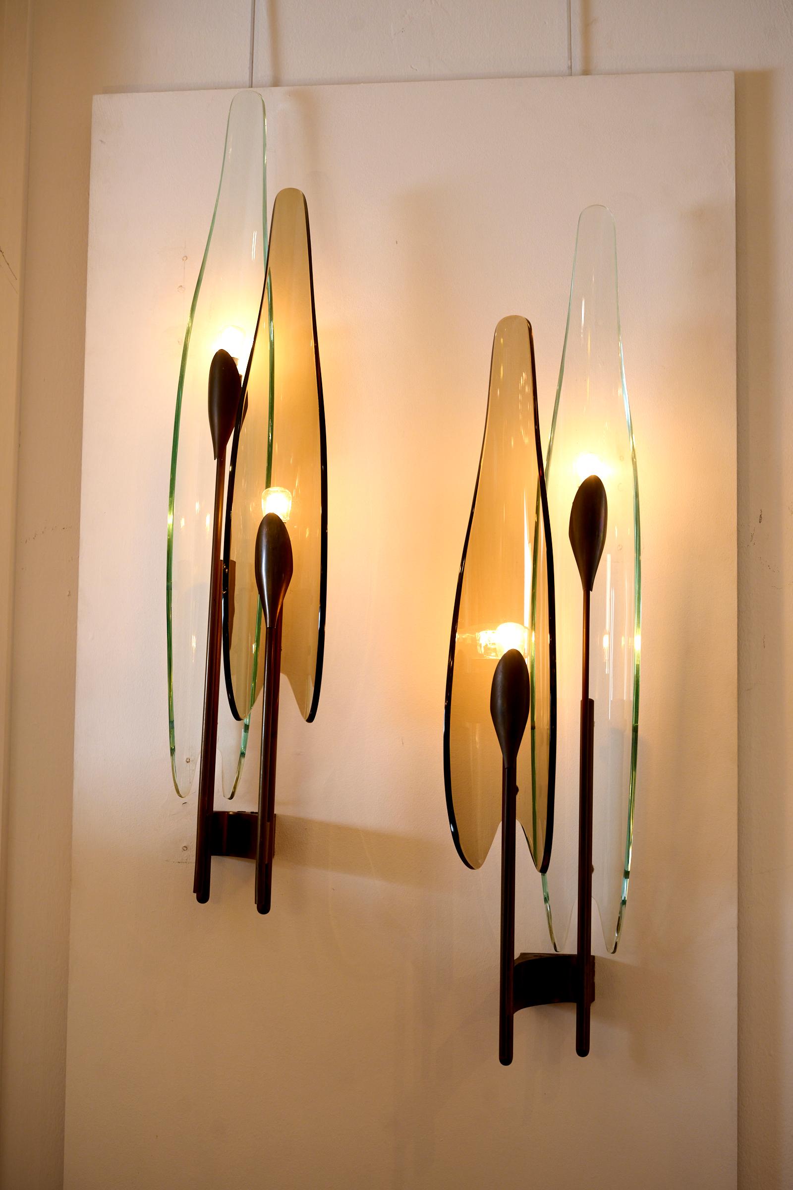 A pair of 'Dahlia' wall lights, model no. 1461, c1950

Manufactured by Fontana Arte, Milan, Italy, tinted glass, brass

each 30 ¼ in. high (77 cm.)