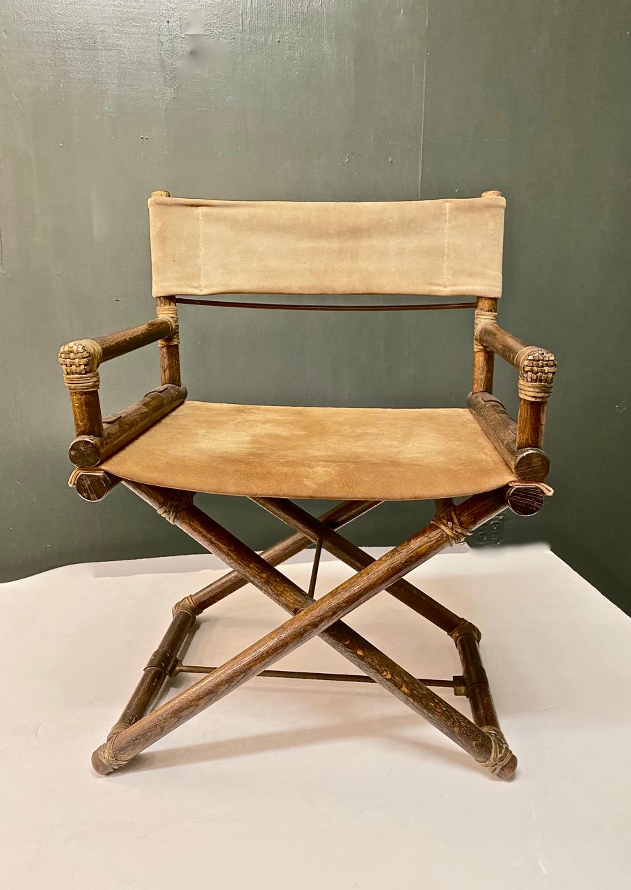 This is a pair of very early McGuire Director's chairs that dates to the late 1950s or early 1960s. The chairs predate the iconic McGuire metallic tag and are marked with a cloth manufacturer's tag. The chairs retain all of their original elements: