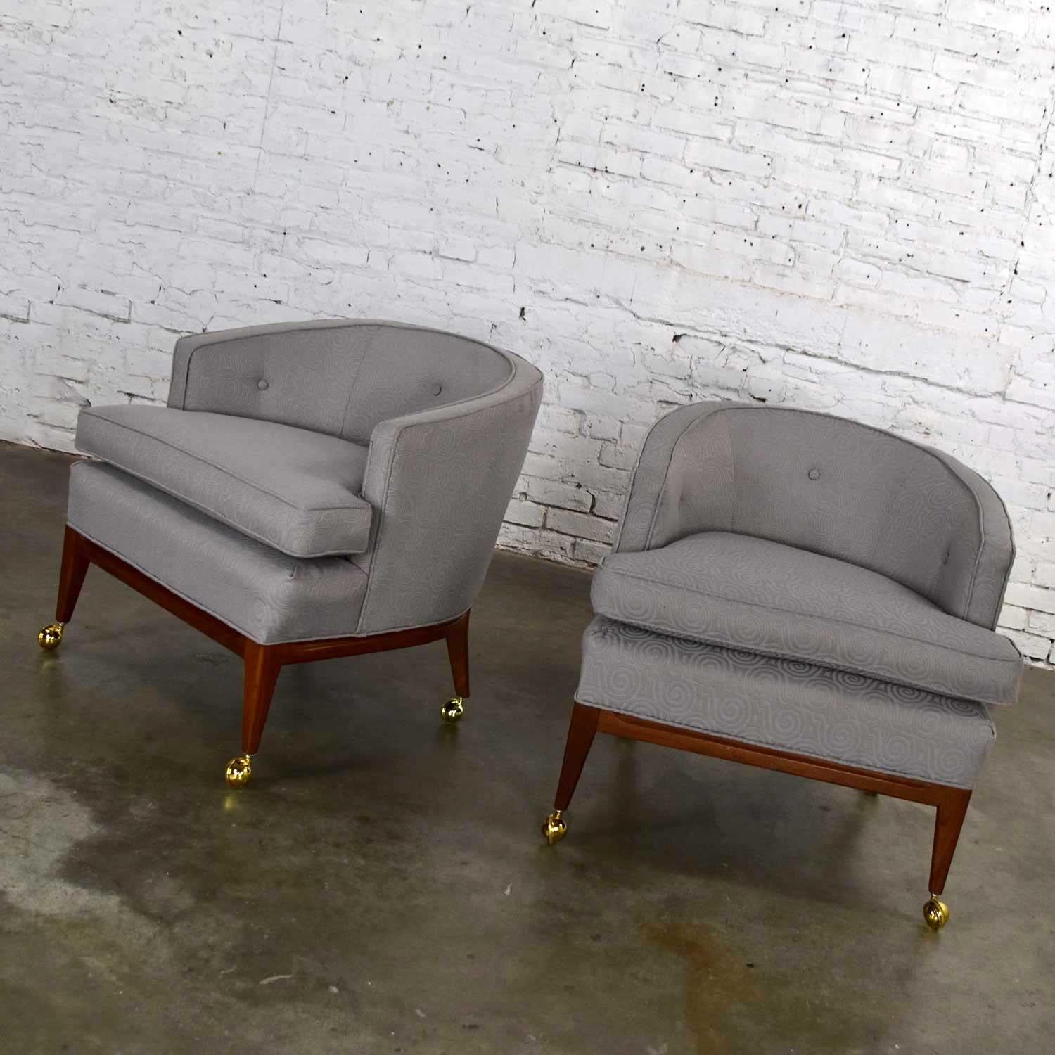Awesome pair of Mid-Century Modern (MCM) barrel back club chairs in the style of Harvey Probber. Newly upholstered in a grey and taupe textured spiral fabric, buttons on the seatbacks, wooden base, and legs with casters. These have been newly