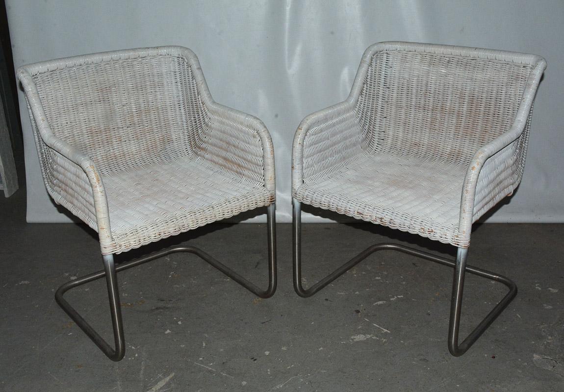 Mid-Century Modern white toned armchairs with wicker structured seats and metal bases. Industrial modern MCM retro look. Can be very useful as extra chairs in a den or office. Measures: Seat height 16.50