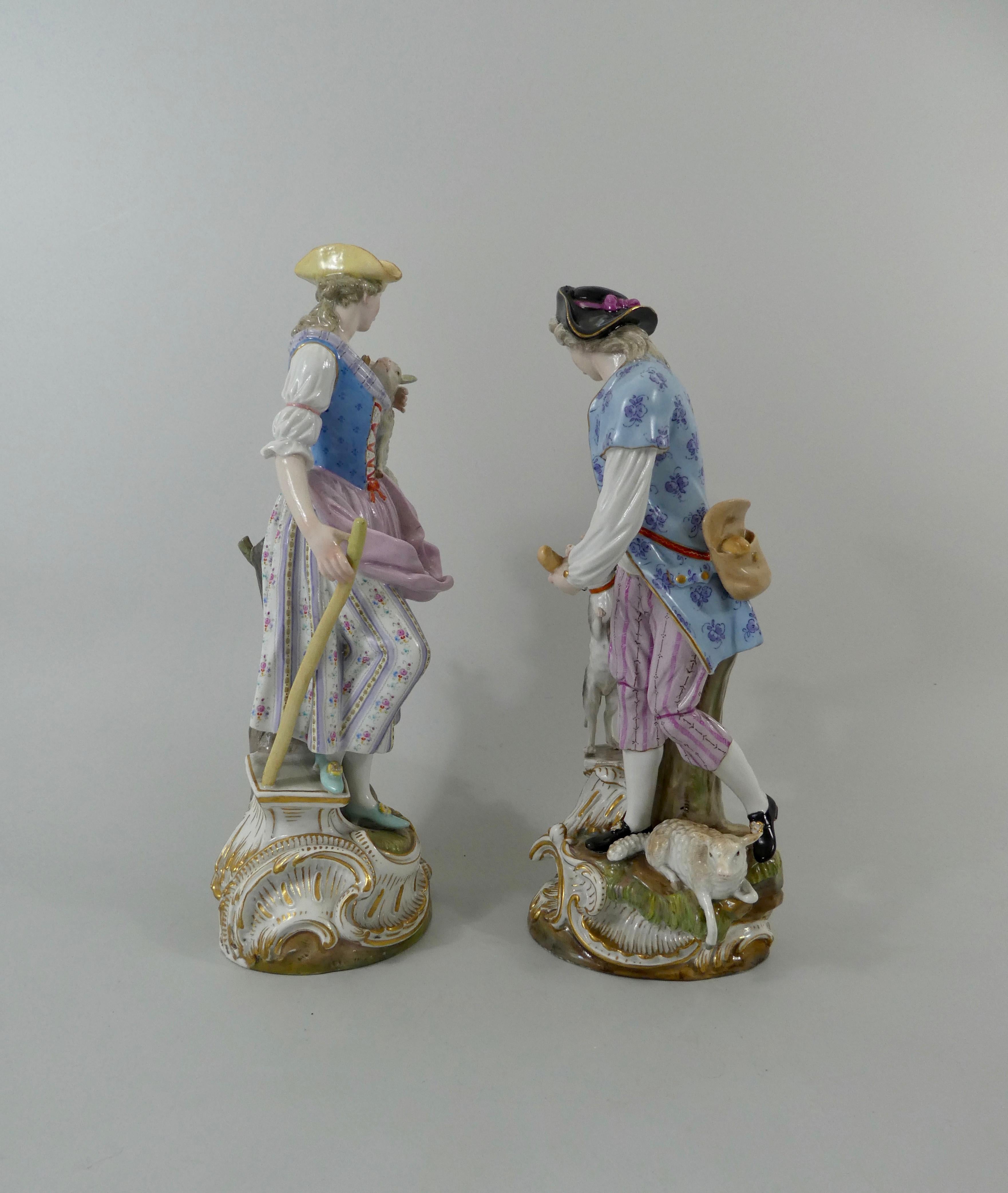 A fine and large pair of Meissen porcelain figures, circa 1870. Beautifully modelled as a shepherd and a shepherdess, with sheep and his dog, and dressed in 18th century costume. Both figures standing before tree stumps, upon grassy mound bases,