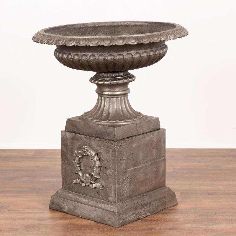 Danish Pair, Mid-20th Century Cast Iron Planting Urns Resting on Square Plinth For Sale