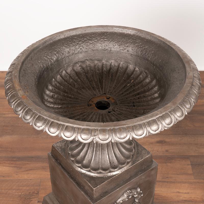 Pair, Mid-20th Century Cast Iron Planting Urns Resting on Square Plinth For Sale 2
