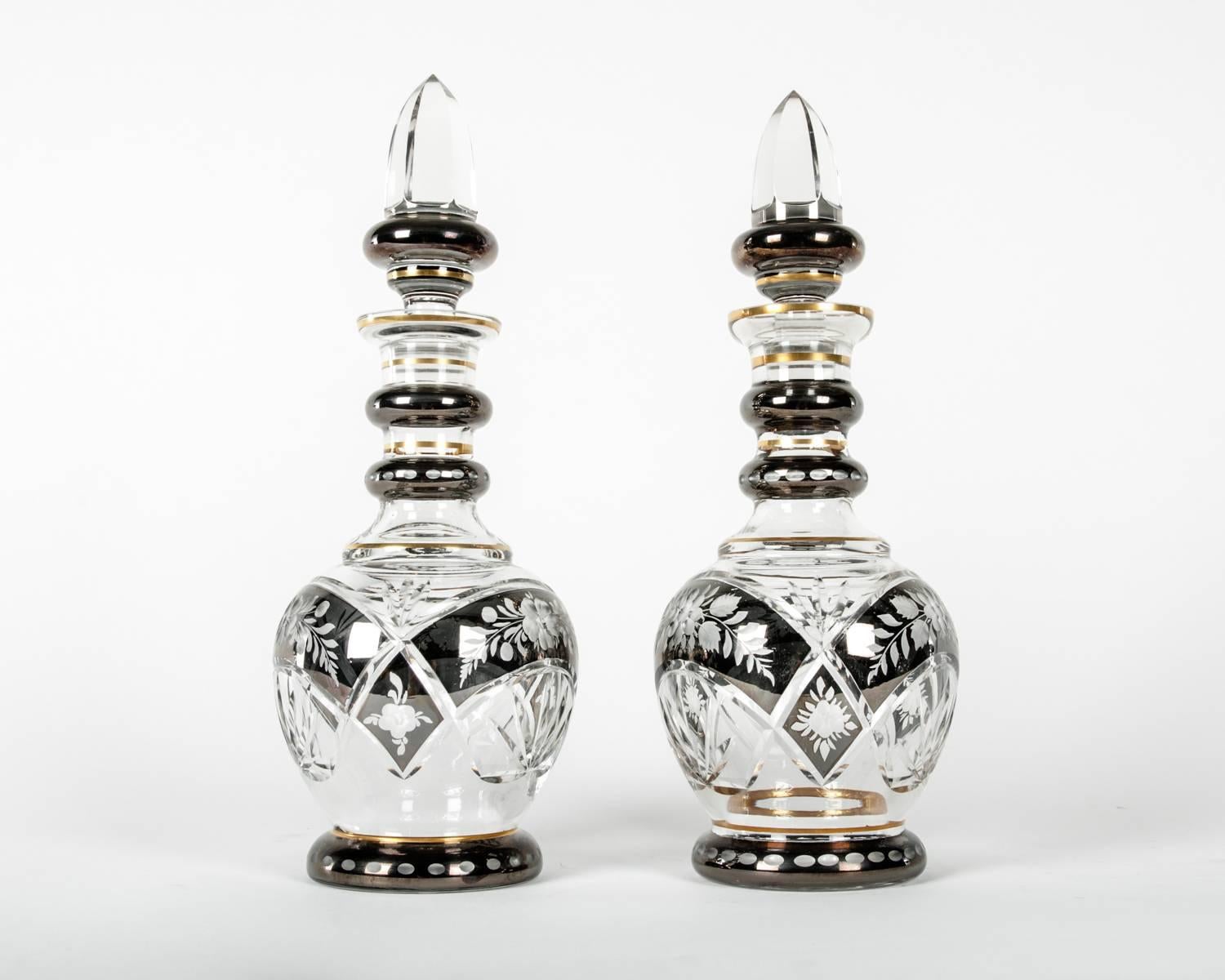 Mid-20th century pair of cut crystal with etched design details and arched band cut and gold trim barware / tableware decanter service. Each decanter is in great vintage condition minor wear consistent with age / use. Each one stands about 13.5