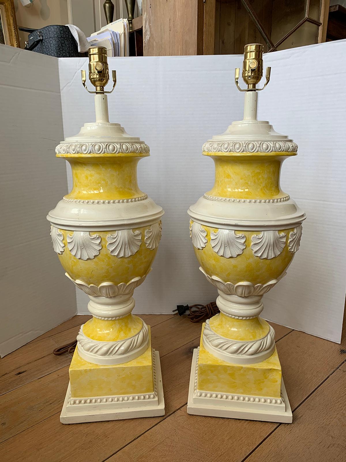 Pair of mid-20th century neoclassical yellow and white glazed urn lamps, shell motif
New wiring.