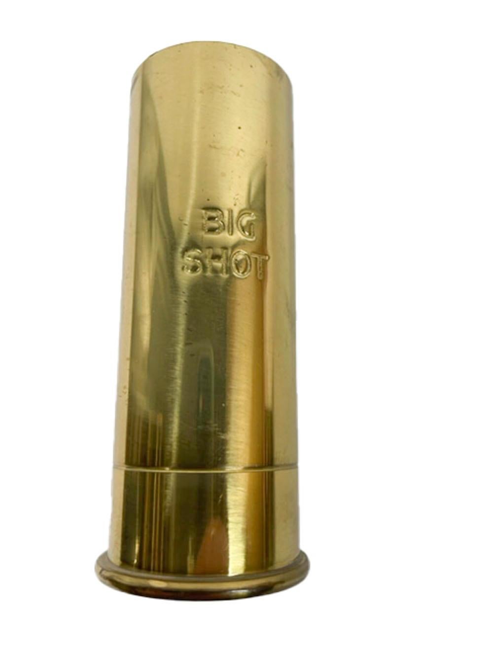 Pair of brass jiggers with removable plastic liners, in the form of shotgun shells one engraved 