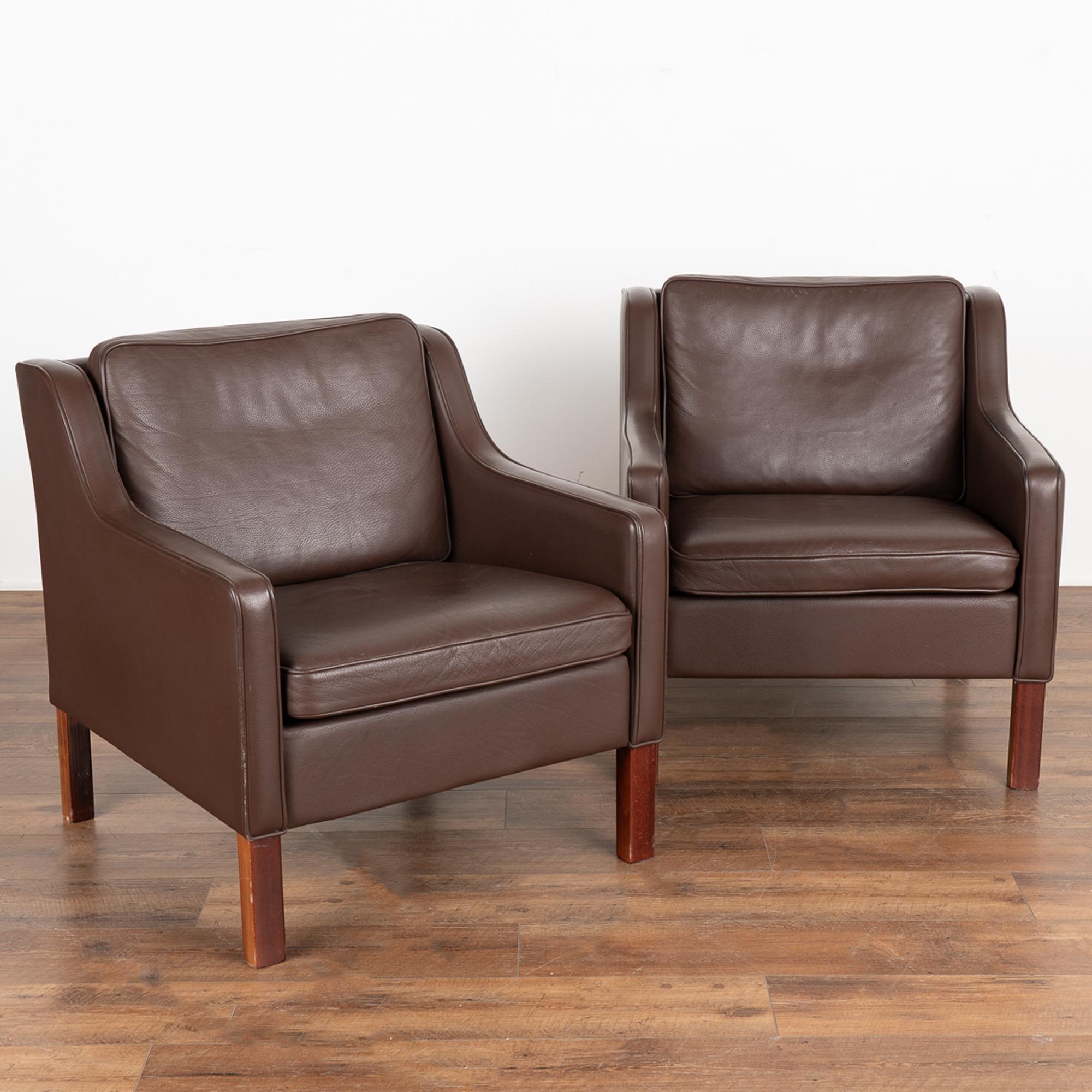Pair, Mid-Century Modern brown leather arm chairs.
Clean modern design with squared arms, these chairs sit comfortably on hard wood feet.
Sold in vintage used condition. Leather shows typical signs of wear including scuffs, scratches, minor
