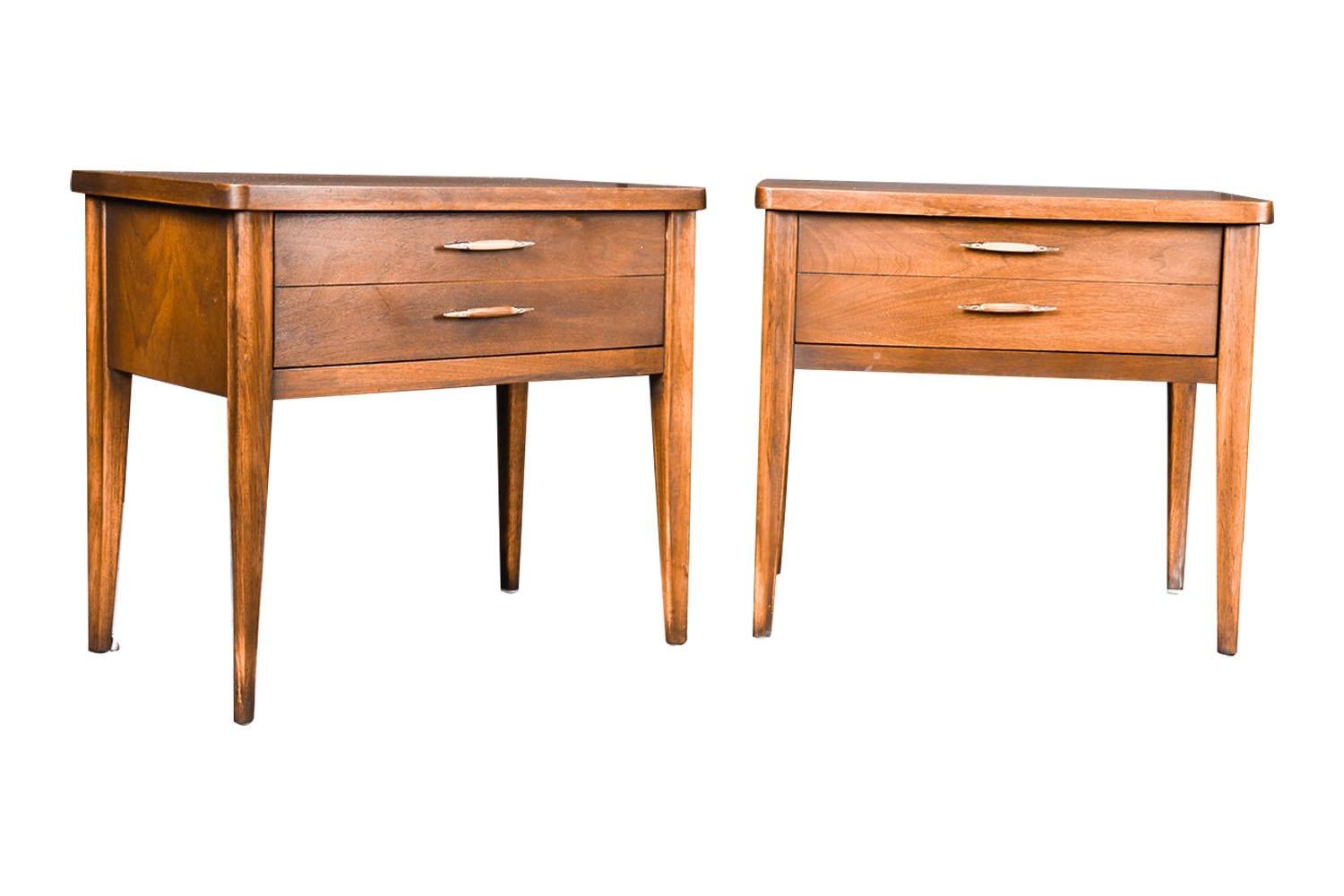 A beautiful pair of vintage, impressive and sleek Mid-Century Modern walnut, nightstands or end tables, circa early 1960s from Broyhill Premier’s “Saga” collection. These absolute jewels remain in nearly pristine condition. The lines are clean and