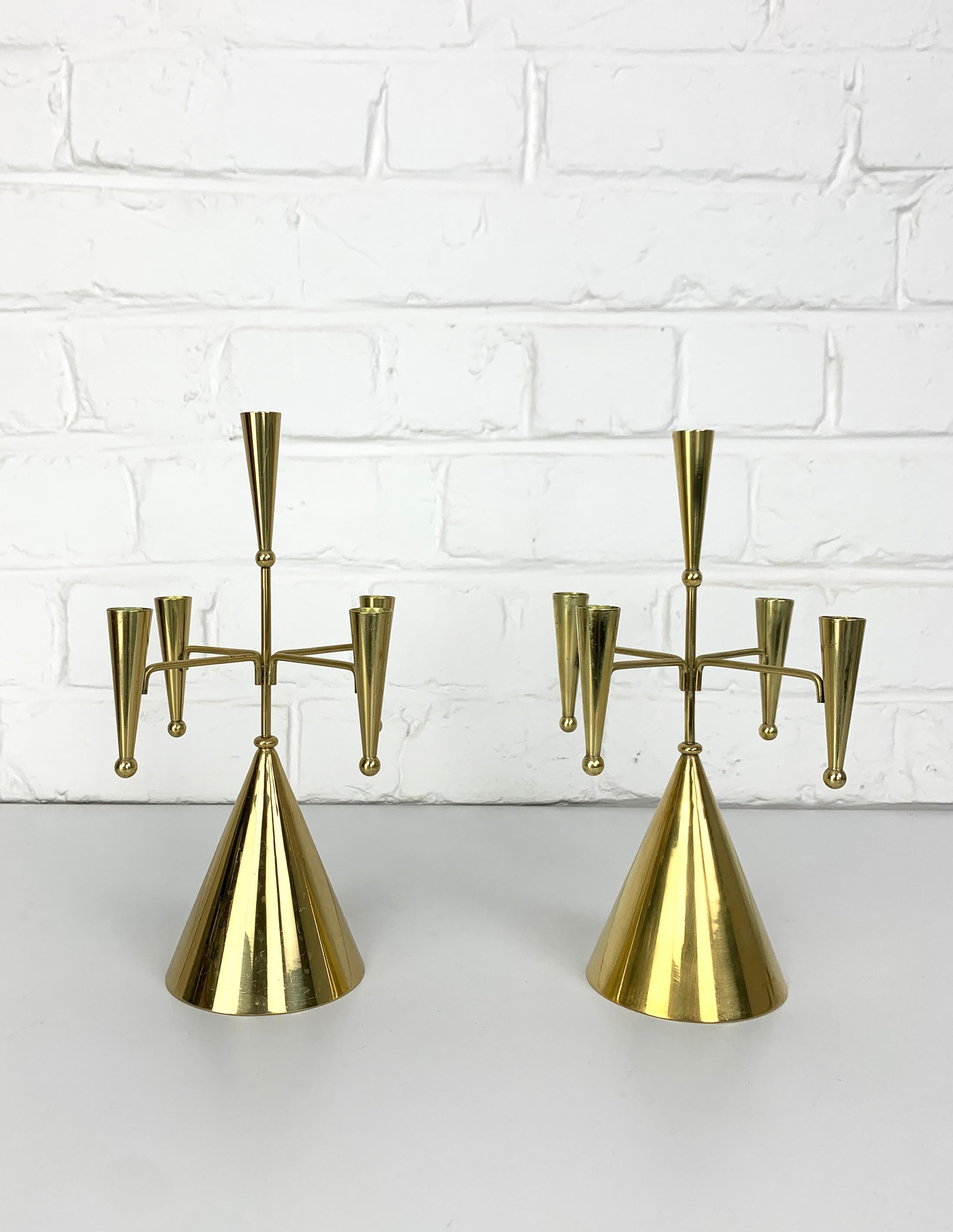 Pair of Swedish Modernist candle holders for 5 candles was designed by Gunnar Ander. Produced by Ystad-Metall, located in the town of Ystad in Sweden. 

Entirely made of brass, this playful design is based on cones and spheres assembled by brass