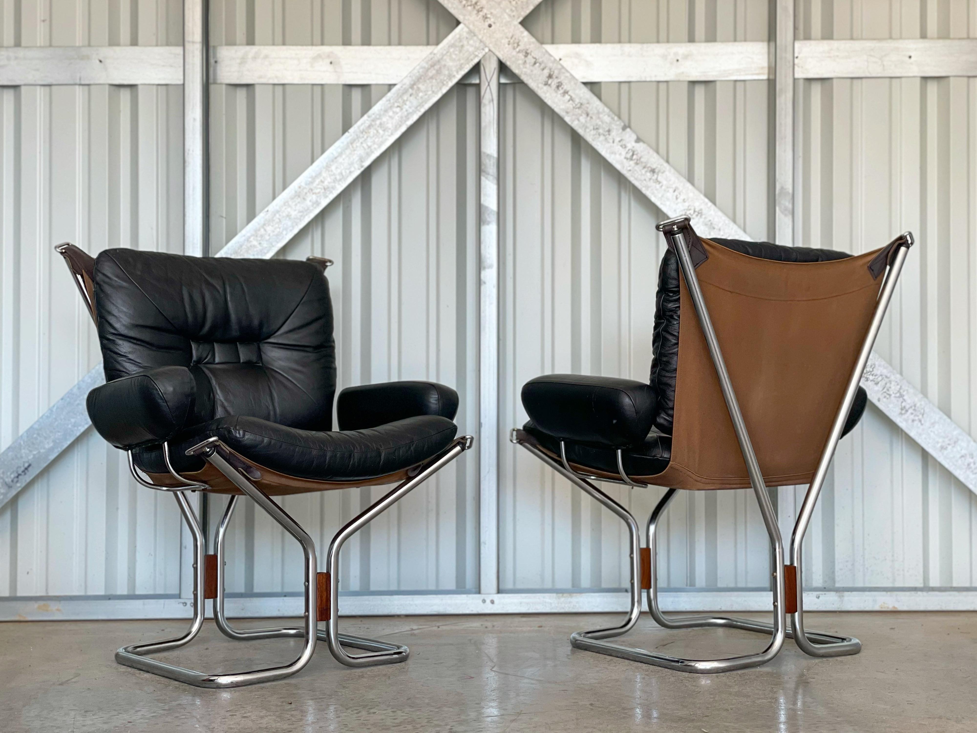 Scandinavian Modern club chairs designed by Ingmar Relling for Westnofa, circa 1970s. Produced in Norway by Westnofa. Perfect juxtaposition of materials; black leather, canvas, chromed steel, brown leather and rosewood. Original black leather