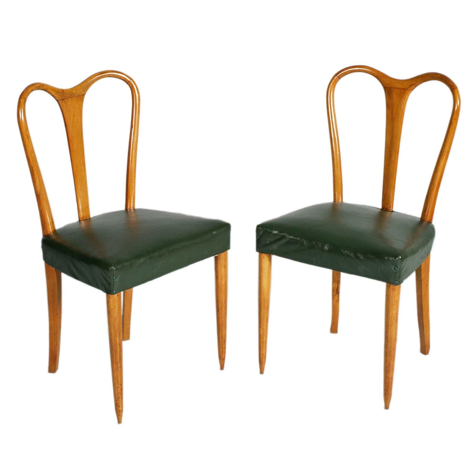 All originals Mid-century elegant and sturdy pair of chairs attributed to Ico Parisi produced by the Rizzi brothers, in beech, with dark green leatherette seat and springs.

About Ico Parisi
Ico Parisi was one of the influential designers who shaped